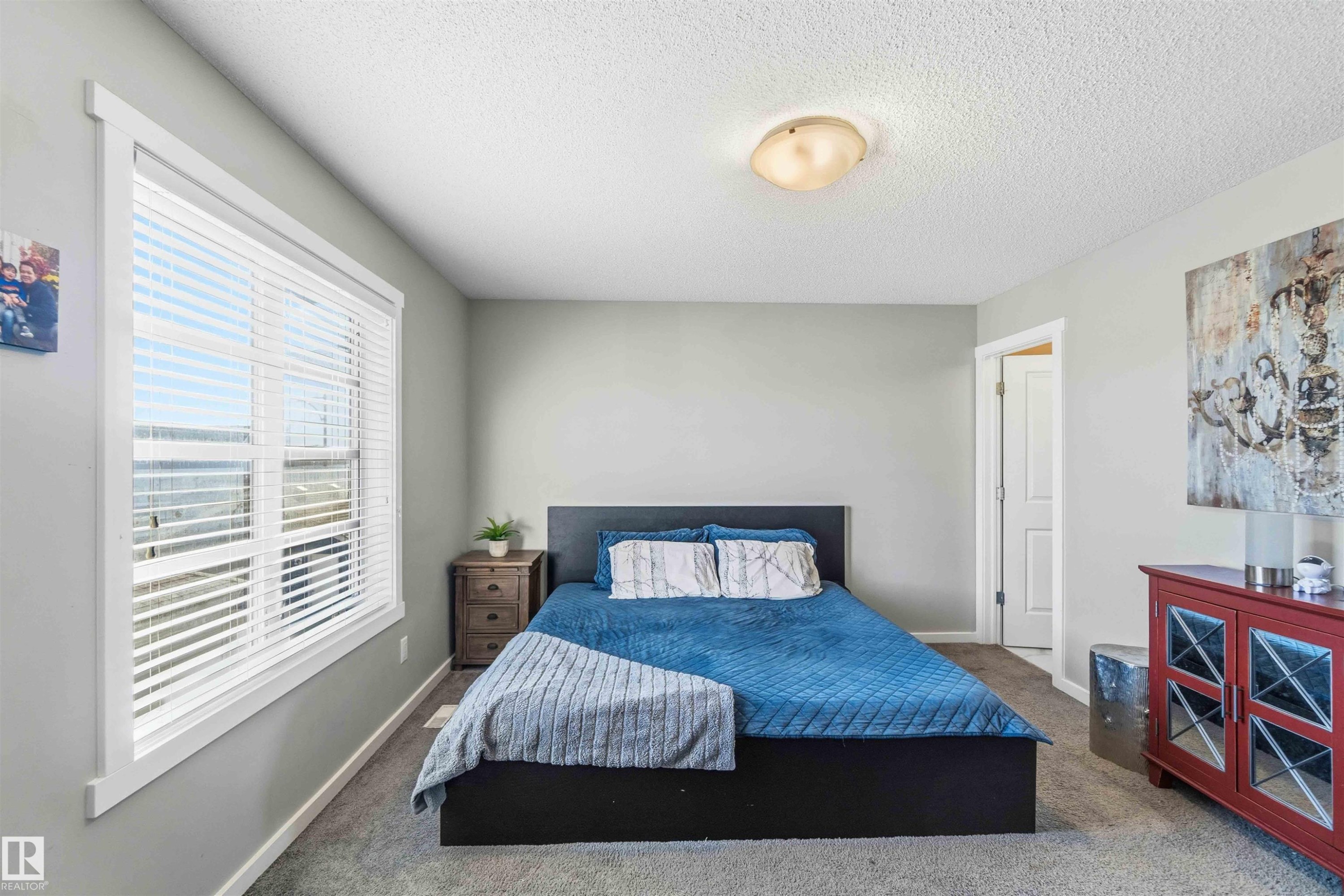 Carpeted bedroom with a textured ceiling and baseboards - 1908 25 Street, Edmonton, AB - Indoor Photo Showing Bedroom