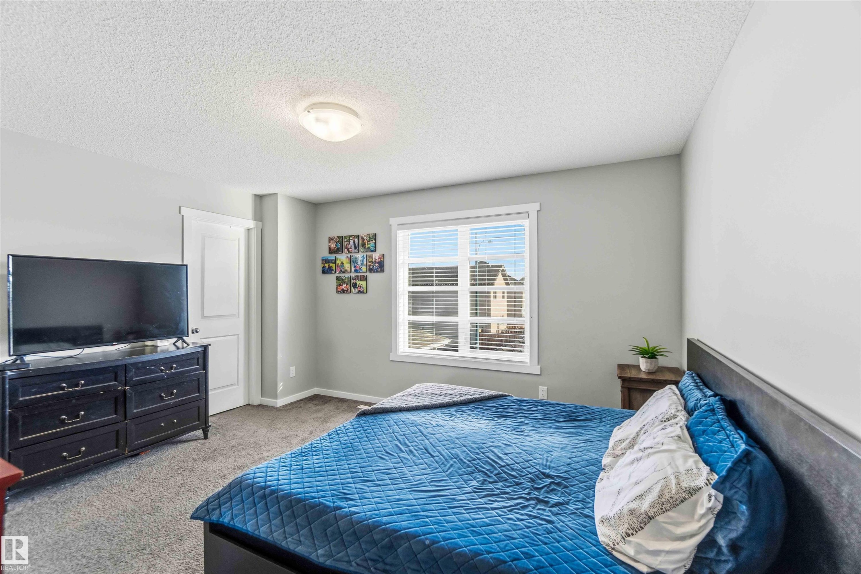 Bedroom with a textured ceiling and light colored carpet - 1908 25 Street, Edmonton, AB - Indoor Photo Showing Bedroom