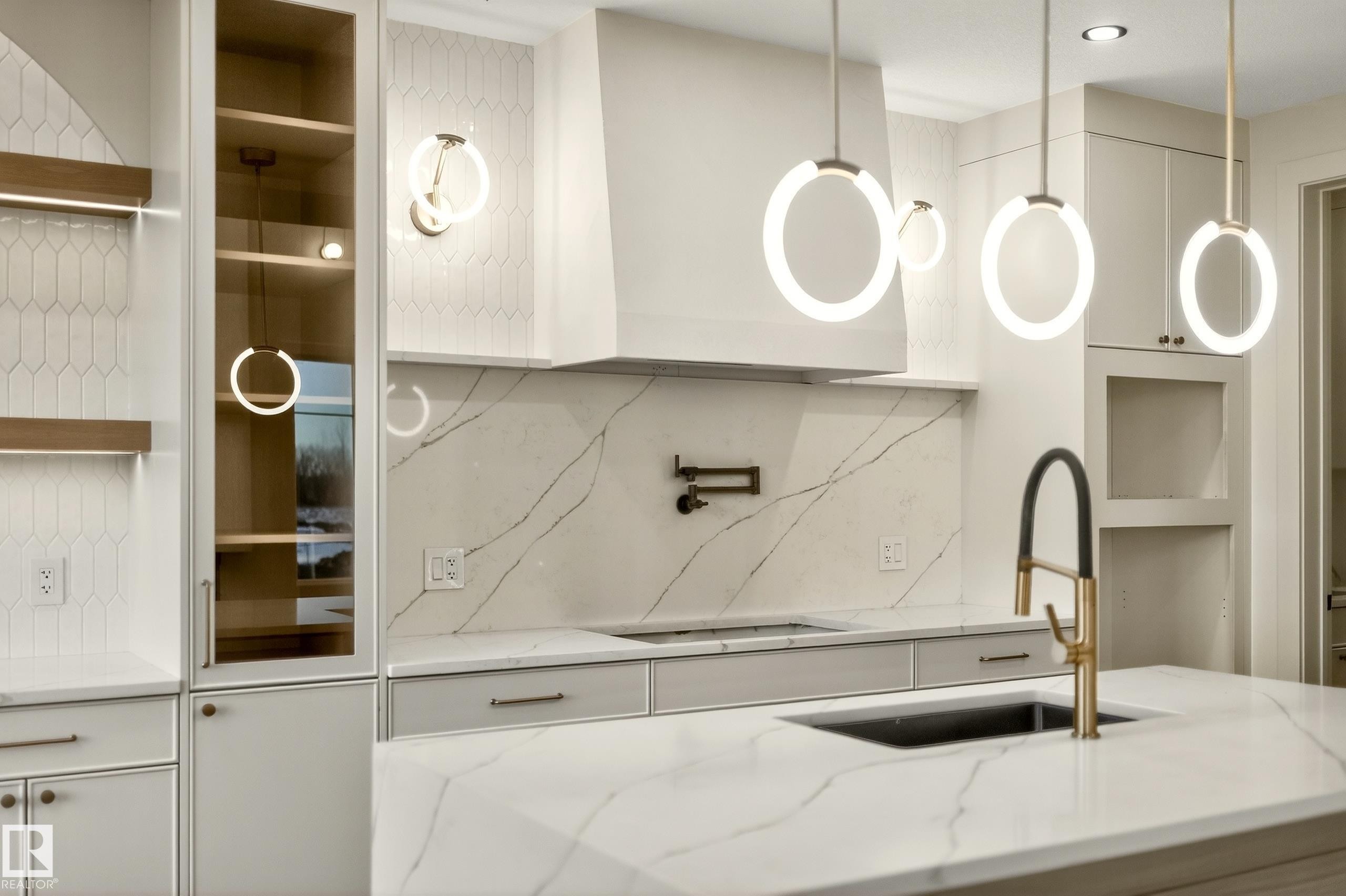 Kitchen featuring decorative backsplash, light stone counters, and white cabinetry - 8924 Mayday Way, Edmonton, AB
