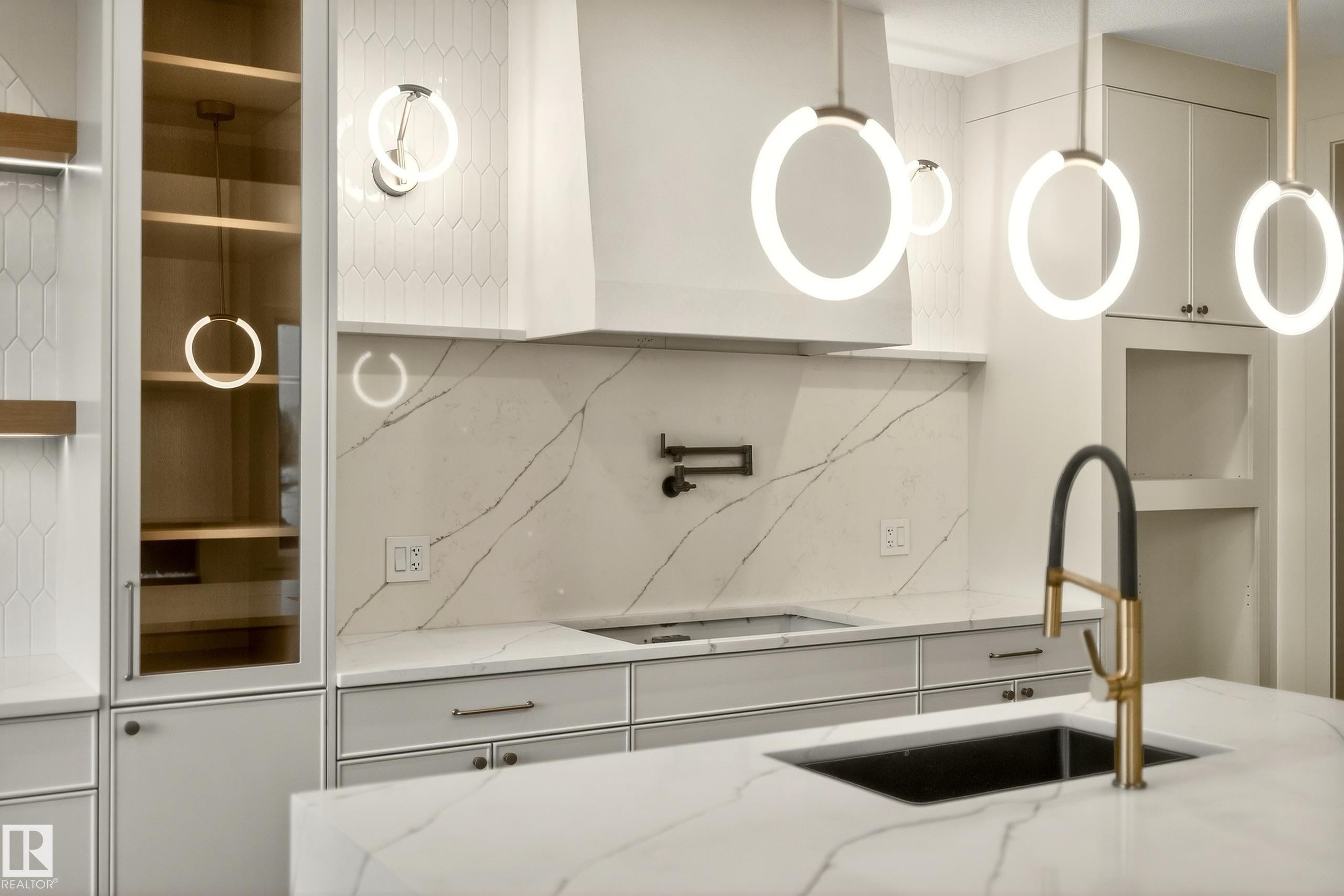 Kitchen featuring backsplash, white cabinets, light stone countertops, and stovetop - 8924 Mayday Way, Edmonton, AB