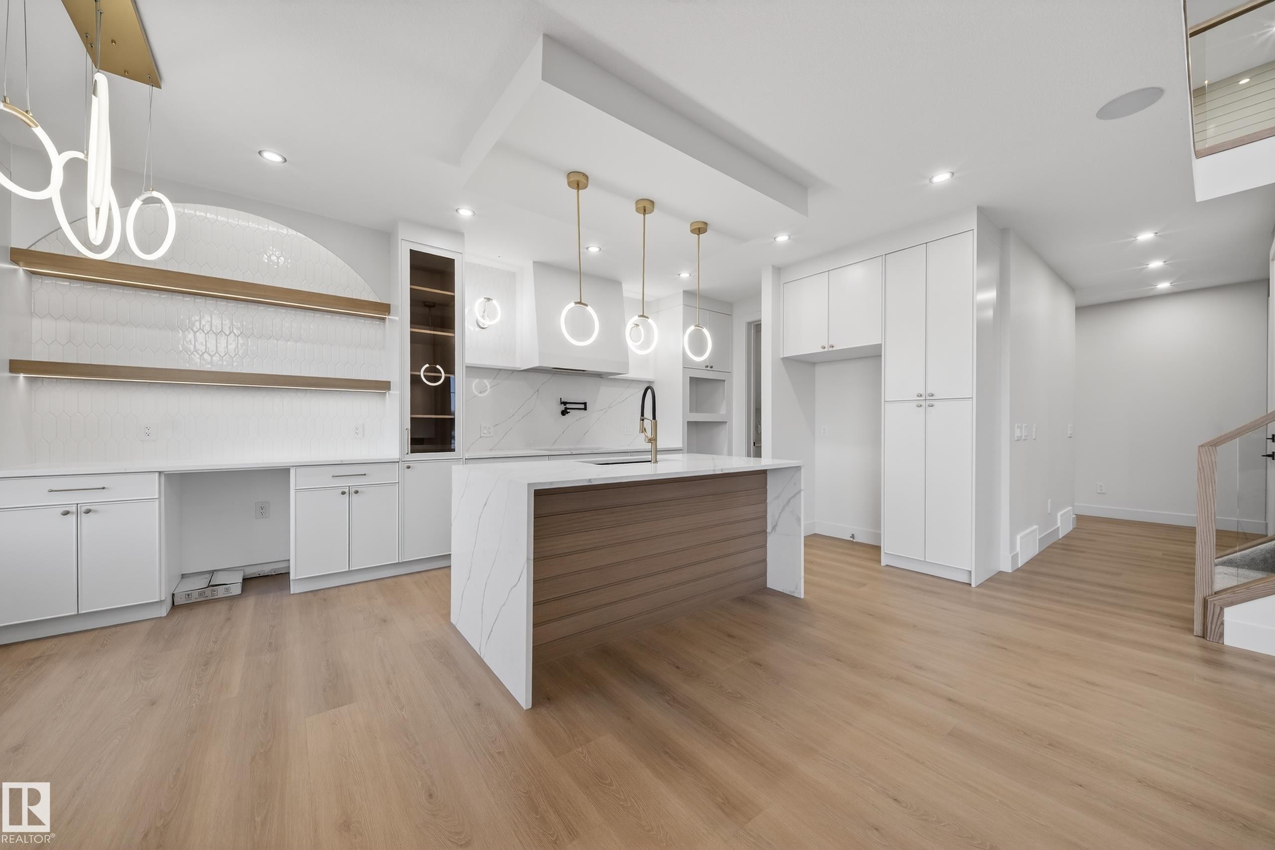 Kitchen with white cabinetry, hanging light fixtures, light stone counters, light wood-style flooring, and open shelves - 8924 Mayday Way, Edmonton, AB