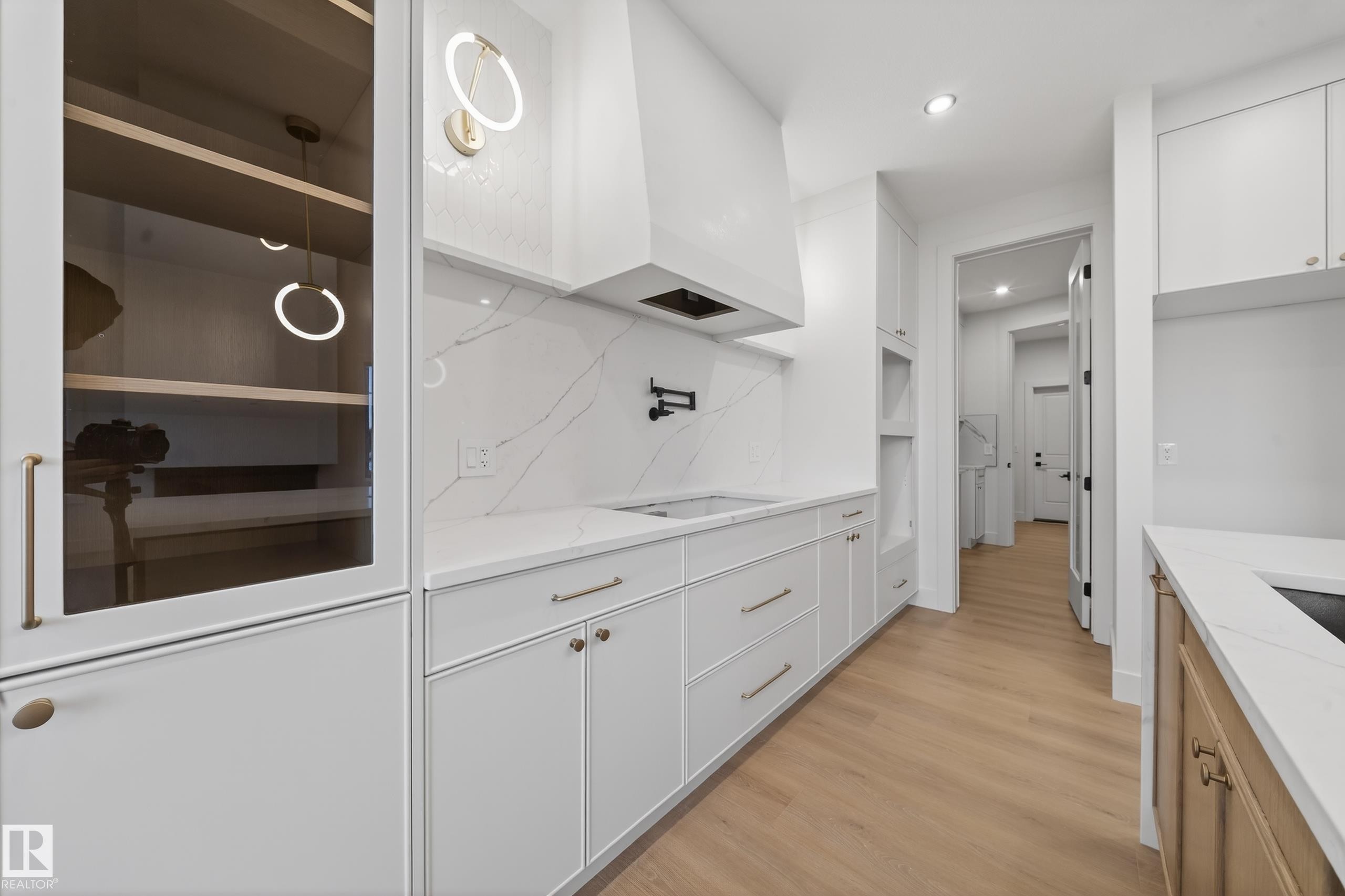 Kitchen with white cabinetry, light wood finished floors, recessed lighting, and light stone countertops - 8924 Mayday Way, Edmonton, AB
