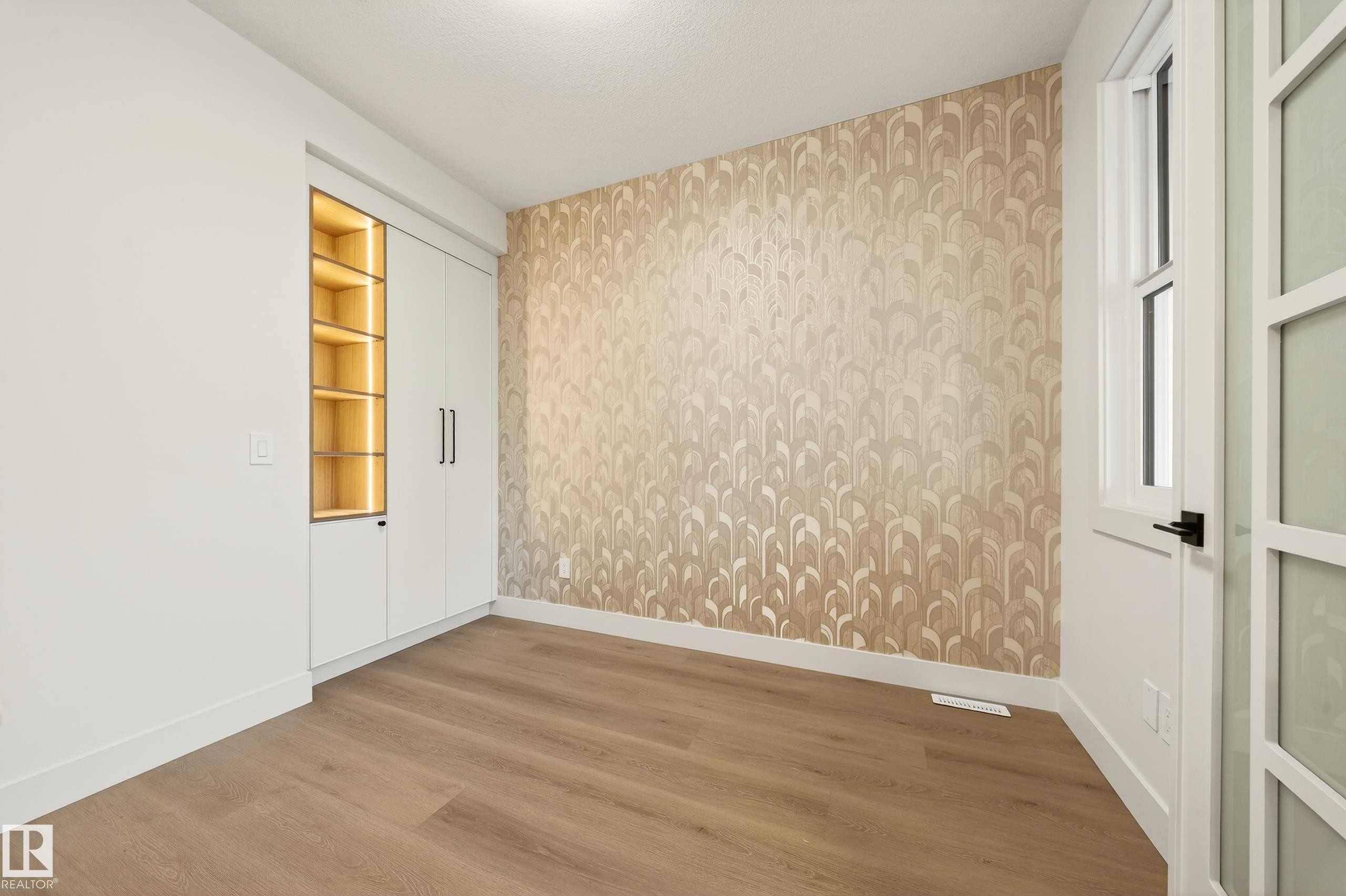 Unfurnished room featuring wood finished floors and wallpapered walls - 8924 Mayday Way, Edmonton, AB