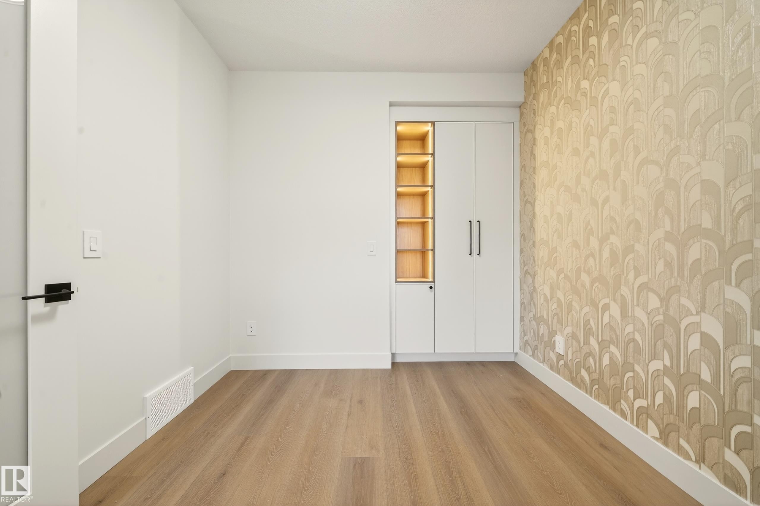 Empty room with light wood-style floors and wallpapered walls - 8924 Mayday Way, Edmonton, AB