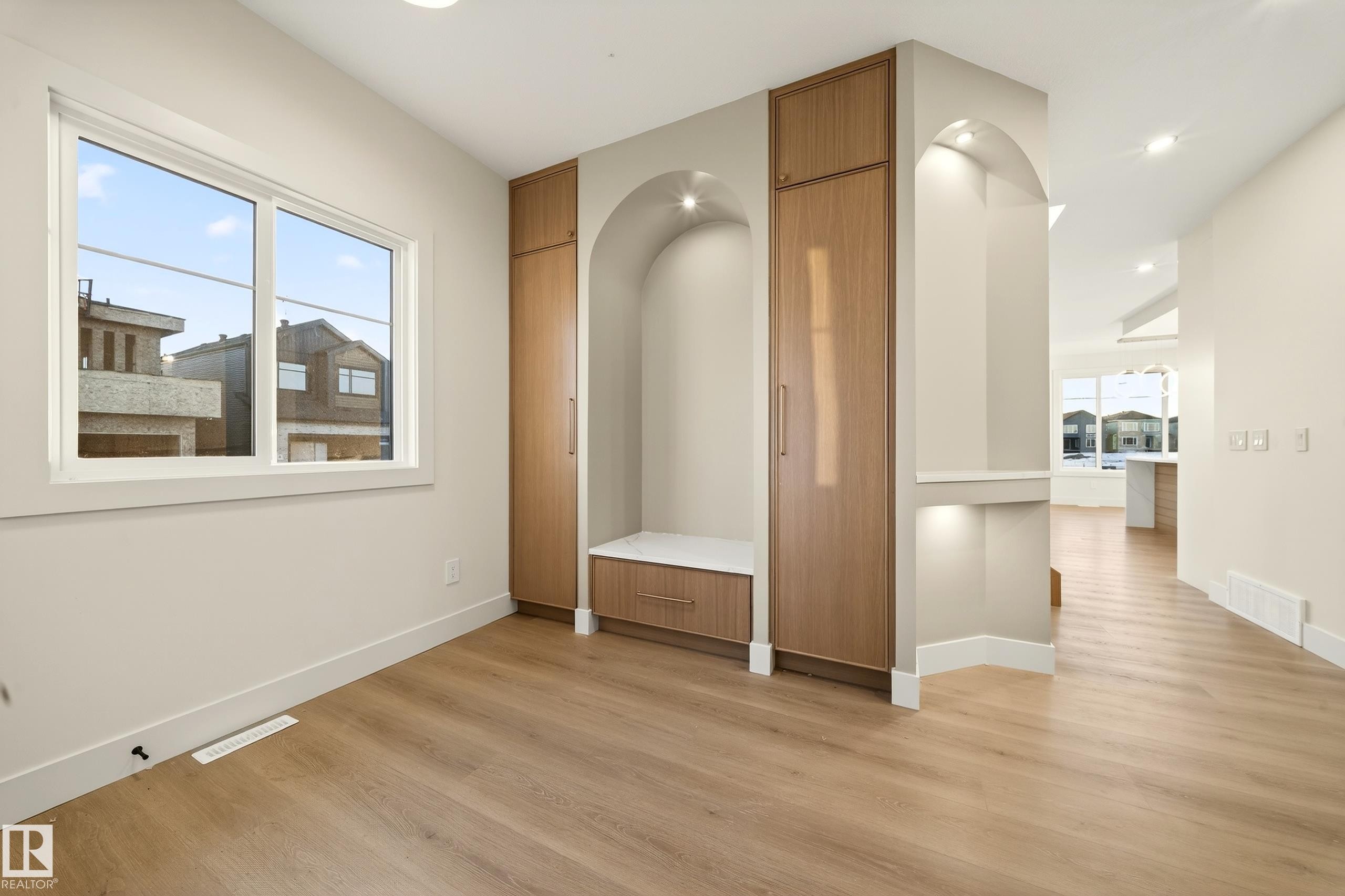Empty room featuring light wood-type flooring and plenty of natural light - 8924 Mayday Way, Edmonton, AB