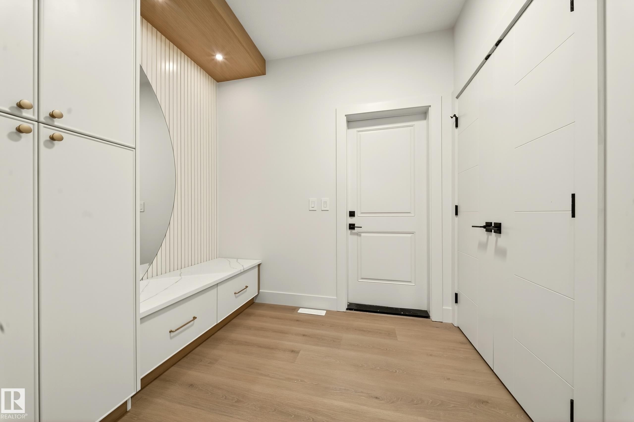 Mudroom with light wood-style floors and recessed lighting - 8924 Mayday Way, Edmonton, AB