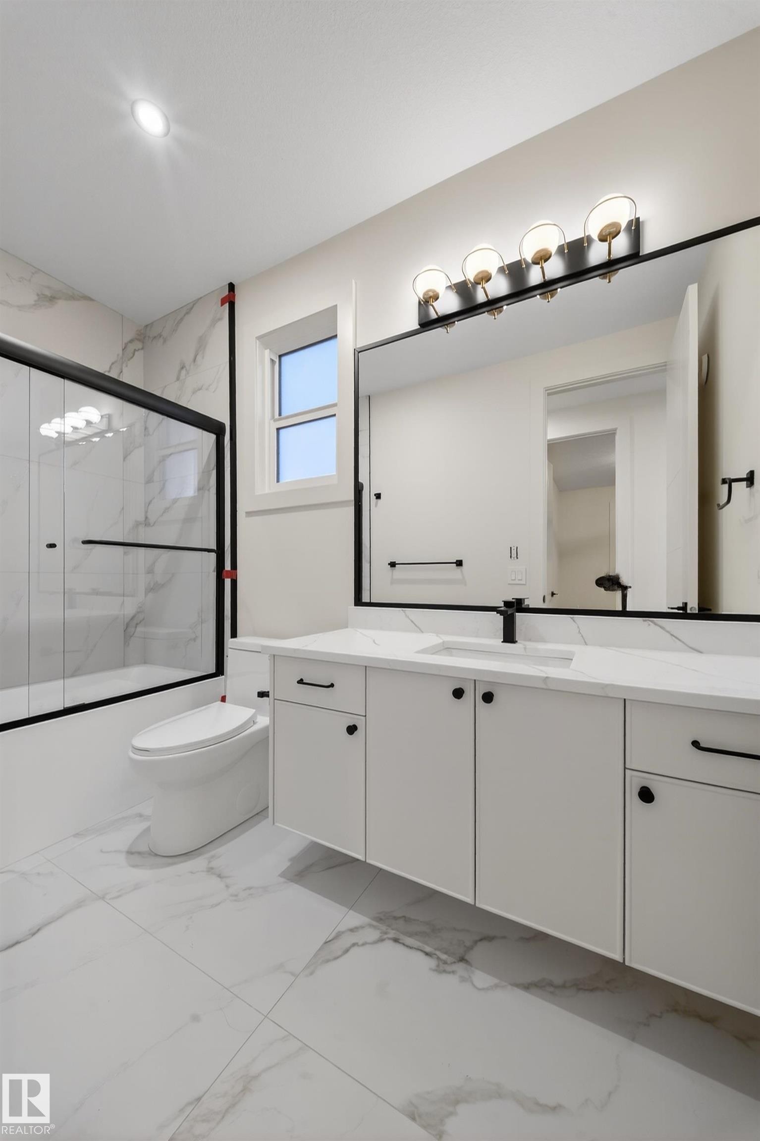 Bathroom with vanity, enclosed tub / shower combo, and light marble finish flooring - 8924 Mayday Way, Edmonton, AB - Indoor Photo Showing Bathroom