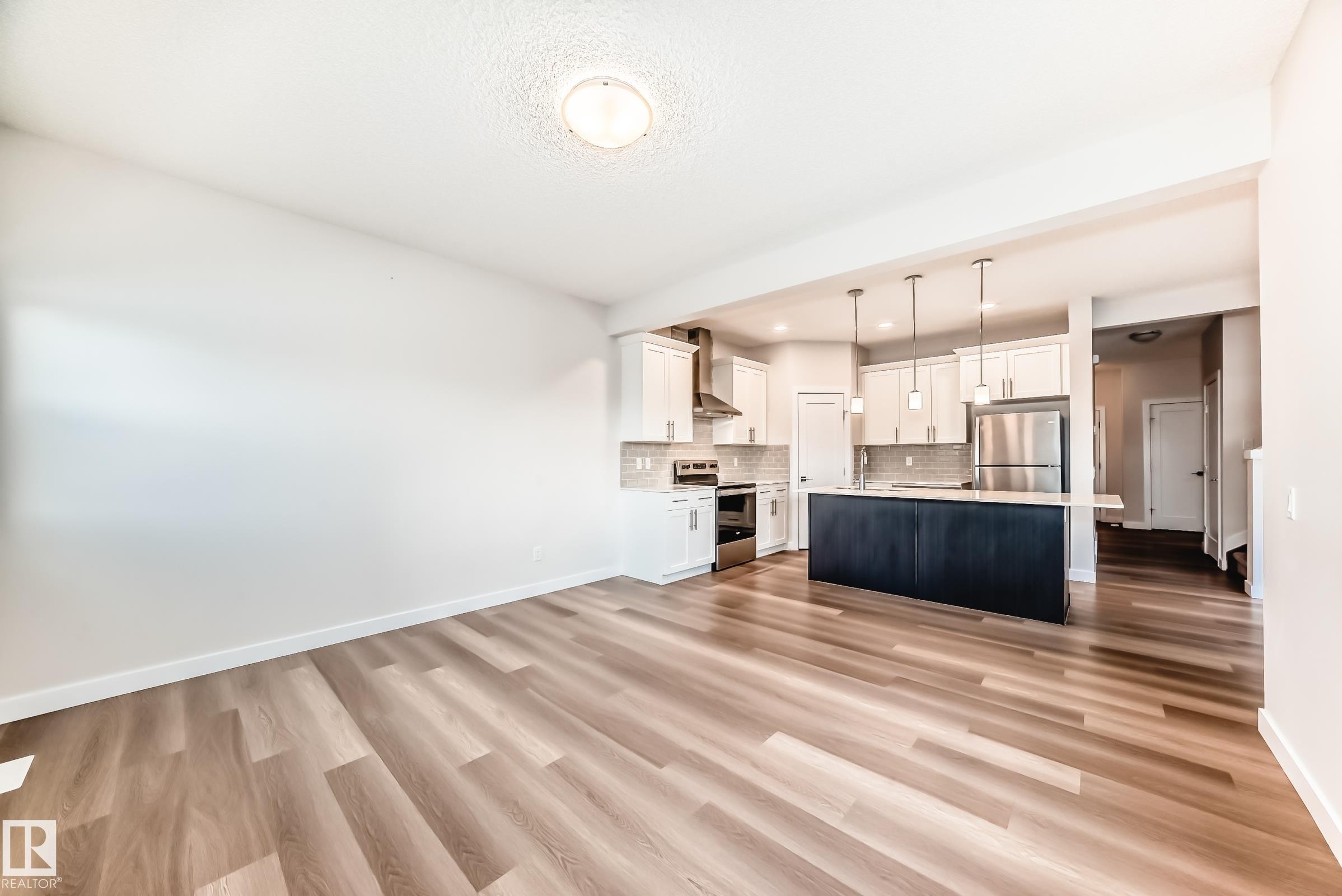 Unfurnished living room with light wood-style floors and recessed lighting - 17926 62A Street, Edmonton, AB - Indoor Photo Showing Kitchen