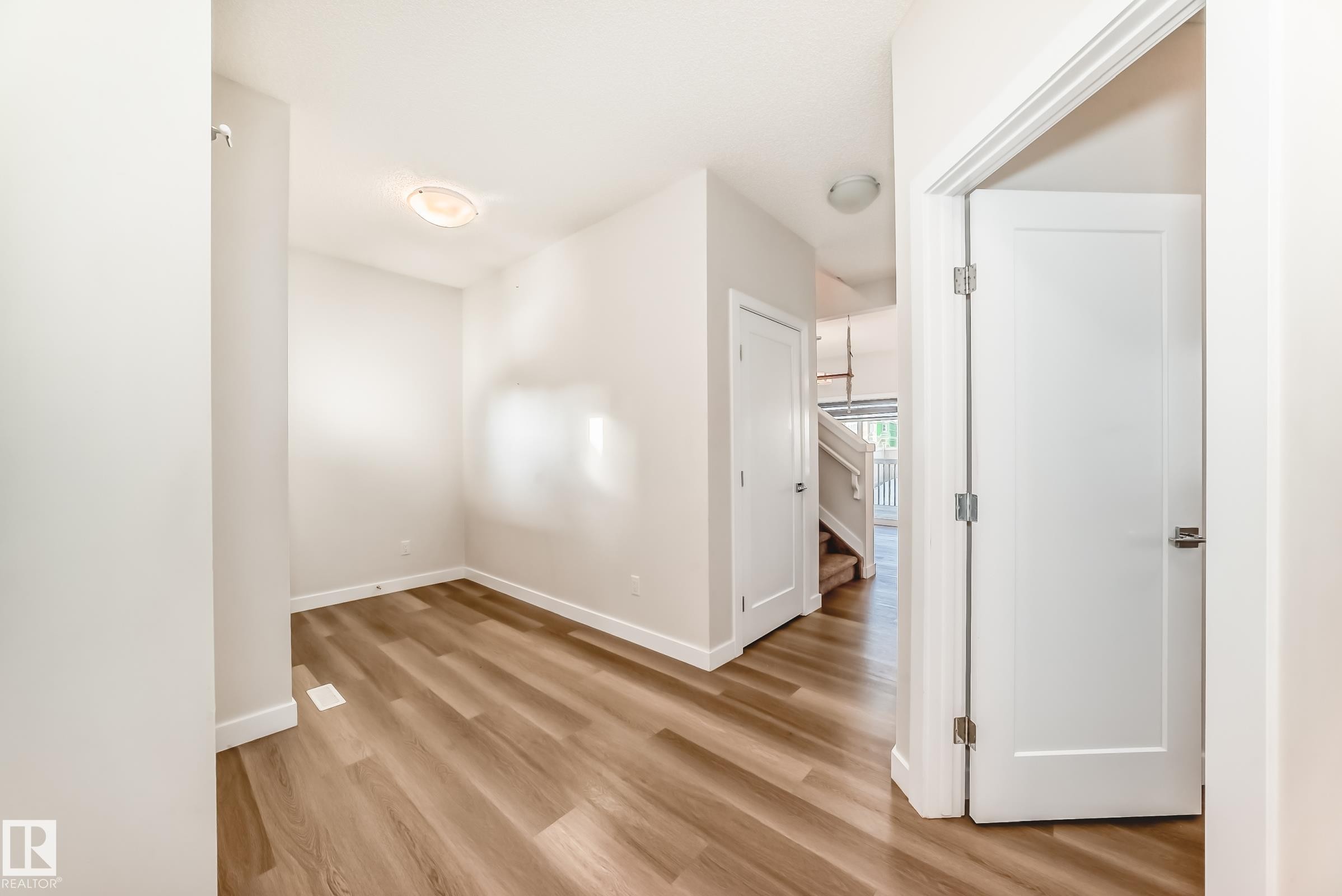 Corridor with light wood-type flooring and baseboards - 17926 62A Street, Edmonton, AB - Indoor Photo Showing Other Room