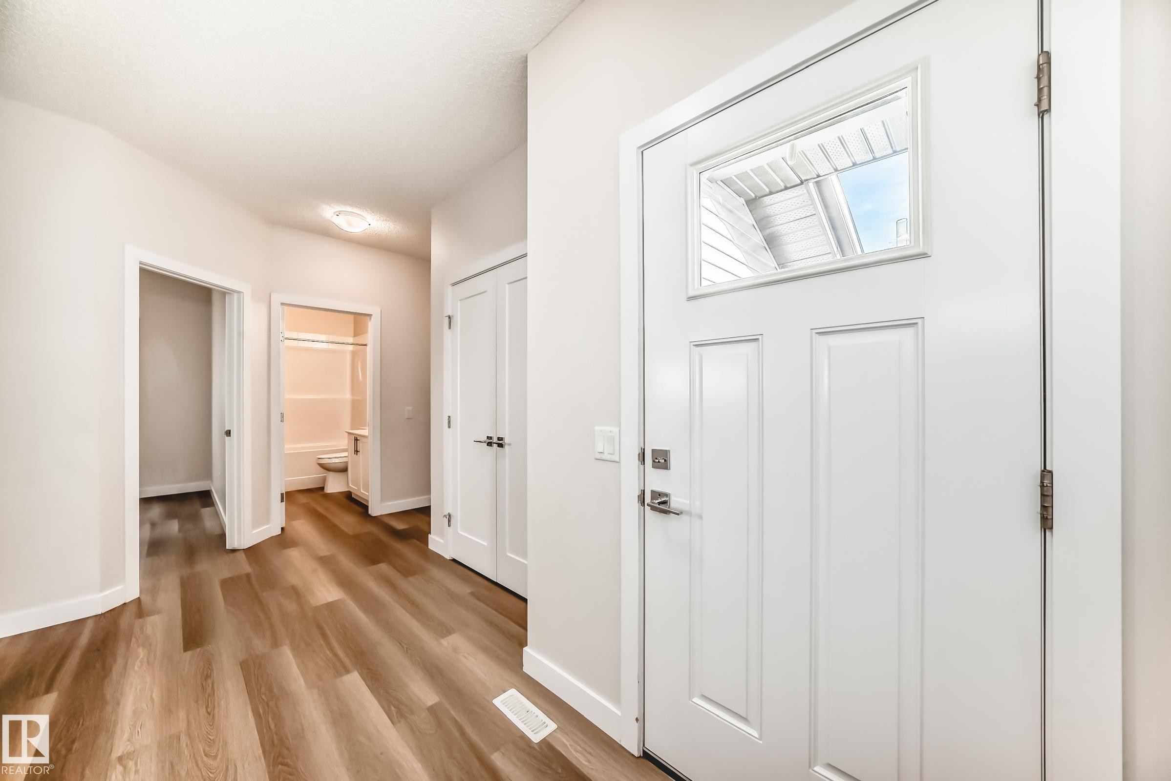 Corridor with baseboards and light wood finished floors - 17926 62A Street, Edmonton, AB - Indoor Photo Showing Other Room
