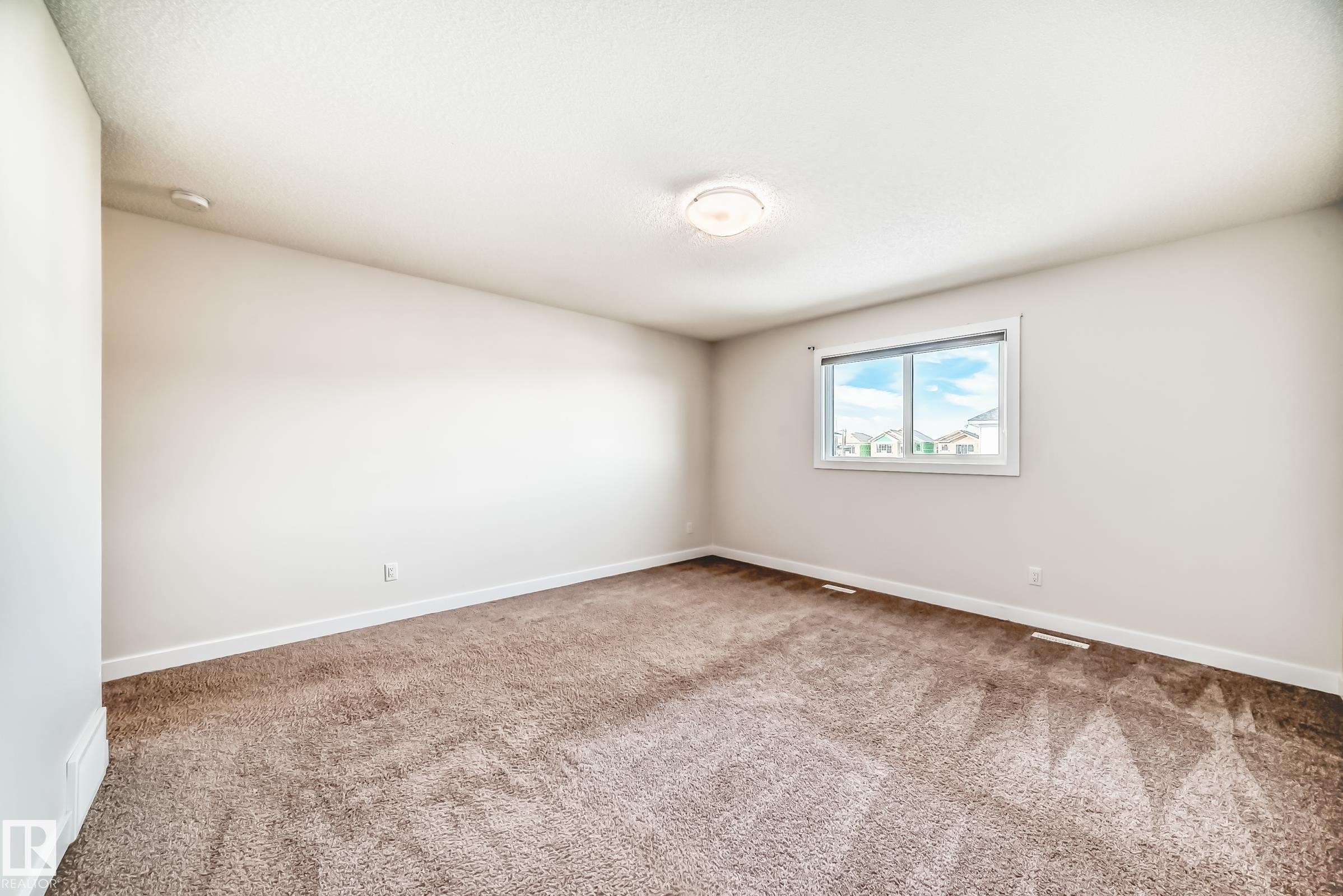 Empty room with baseboards and light carpet - 17926 62A Street, Edmonton, AB - Indoor Photo Showing Other Room