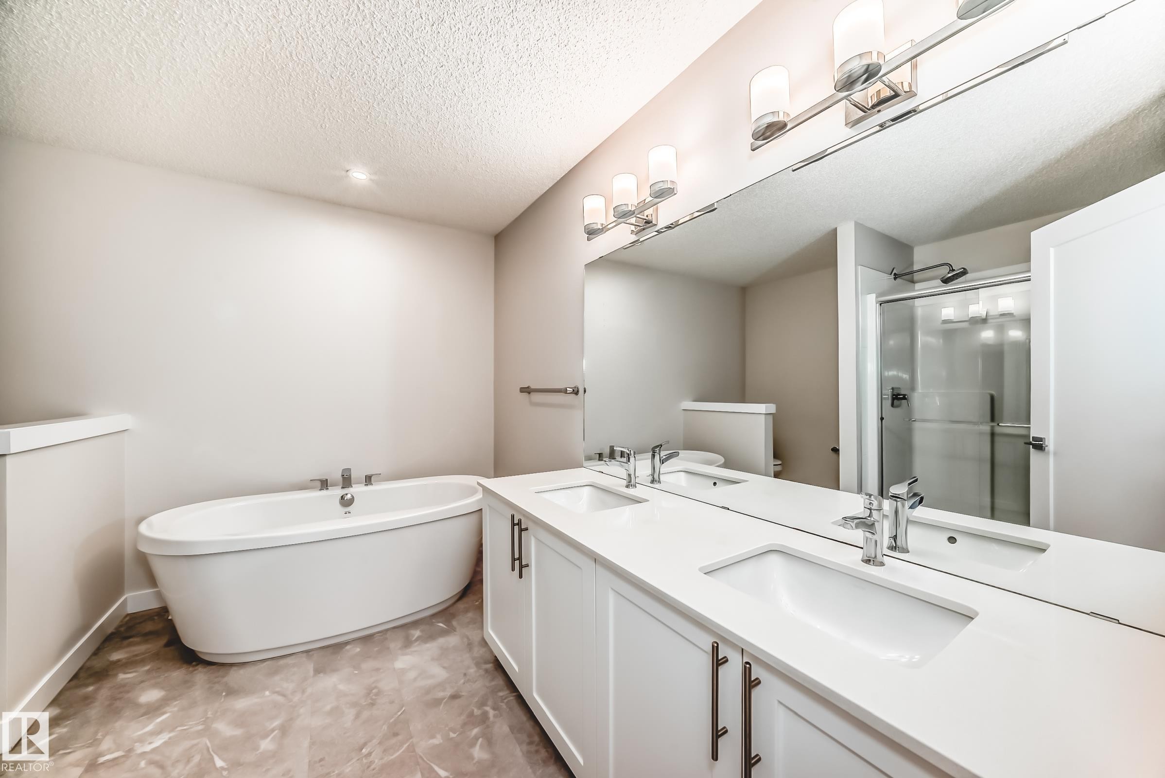 Full bathroom with a shower stall, double vanity, a soaking tub, a textured ceiling, and recessed lighting - 17926 62A Street, Edmonton, AB - Indoor Photo Showing Bathroom