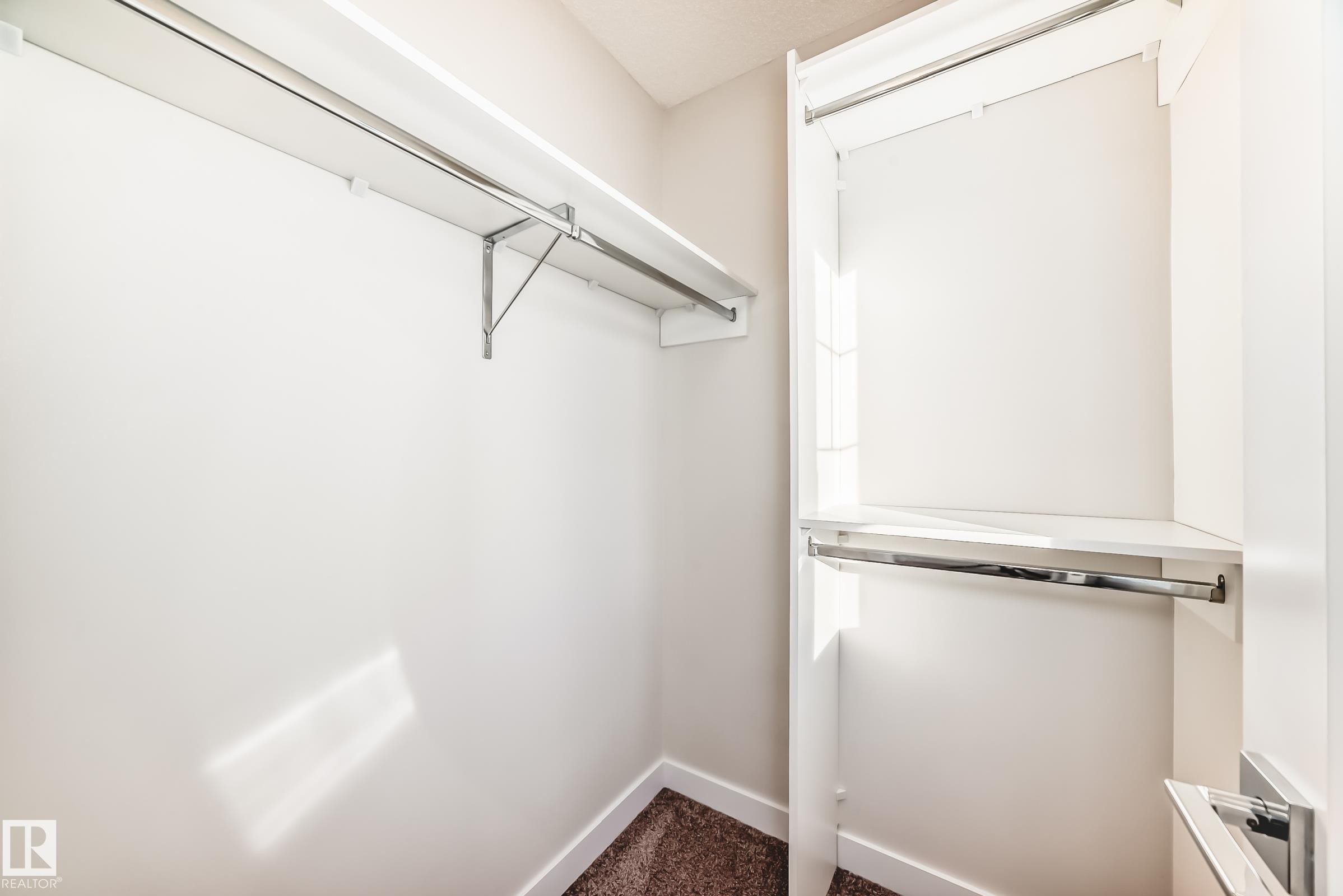 Walk in closet with dark colored carpet - 17926 62A Street, Edmonton, AB - Indoor With Storage