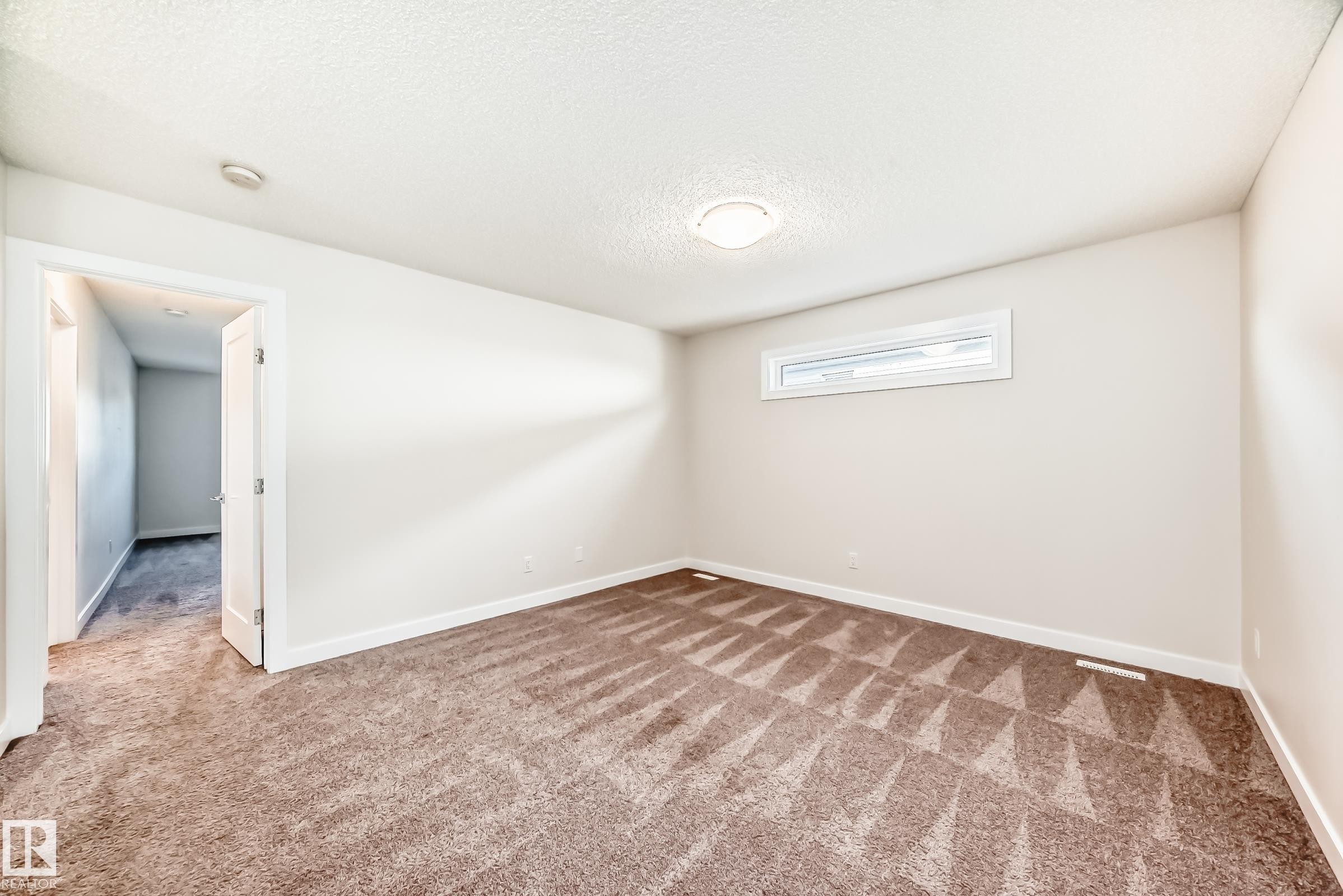 Spare room featuring carpet floors and a textured ceiling - 17926 62A Street, Edmonton, AB - Indoor Photo Showing Other Room