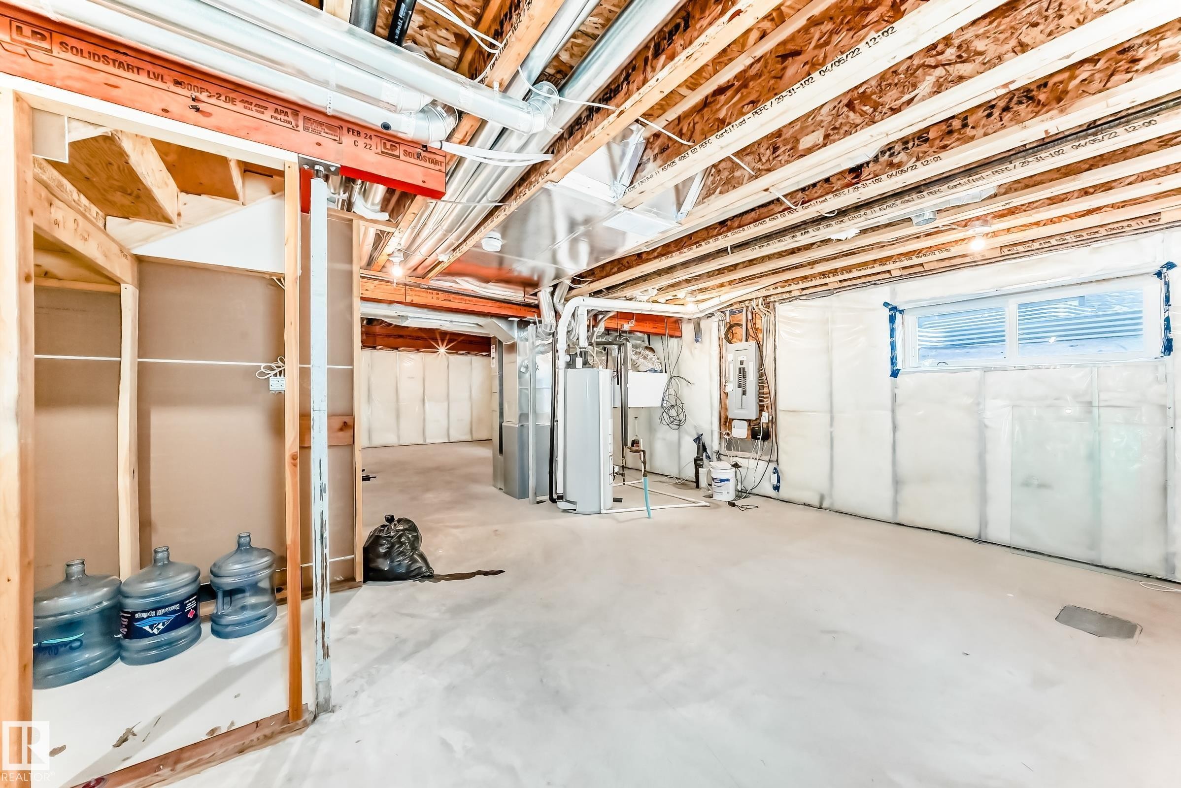 Basement featuring water heater, heating unit, and electric panel - 17926 62A Street, Edmonton, AB - Indoor Photo Showing Basement