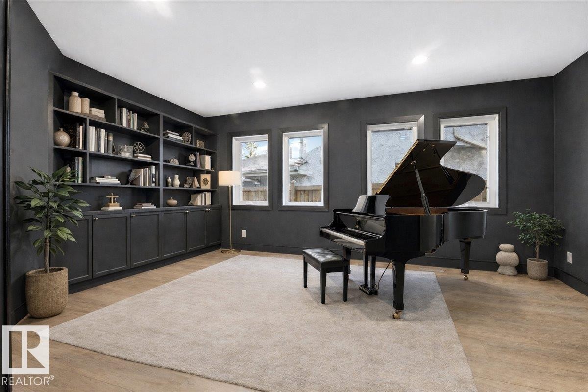 Sitting room with light wood-type flooring, recessed lighting, and built in shelves - 218 Omand Drive, Edmonton, AB - Indoor