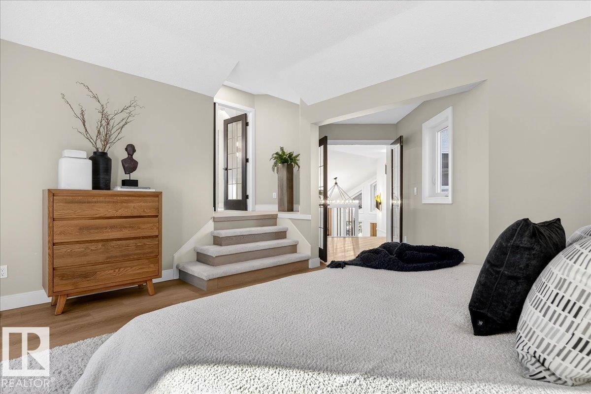 Bedroom with wood finished floors and baseboards - 218 Omand Drive, Edmonton, AB - Indoor Photo Showing Bedroom