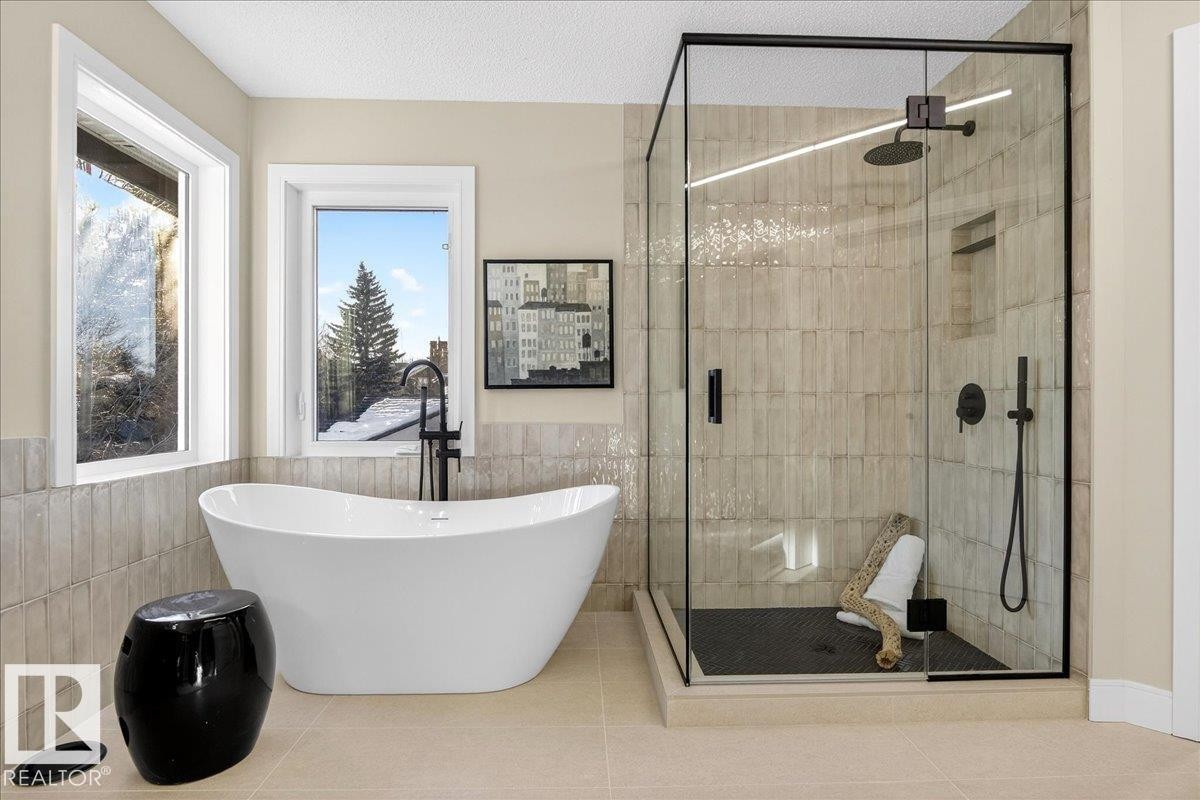 Full bath with a stall shower, a soaking tub, and tile patterned floors - 218 Omand Drive, Edmonton, AB - Indoor Photo Showing Bathroom