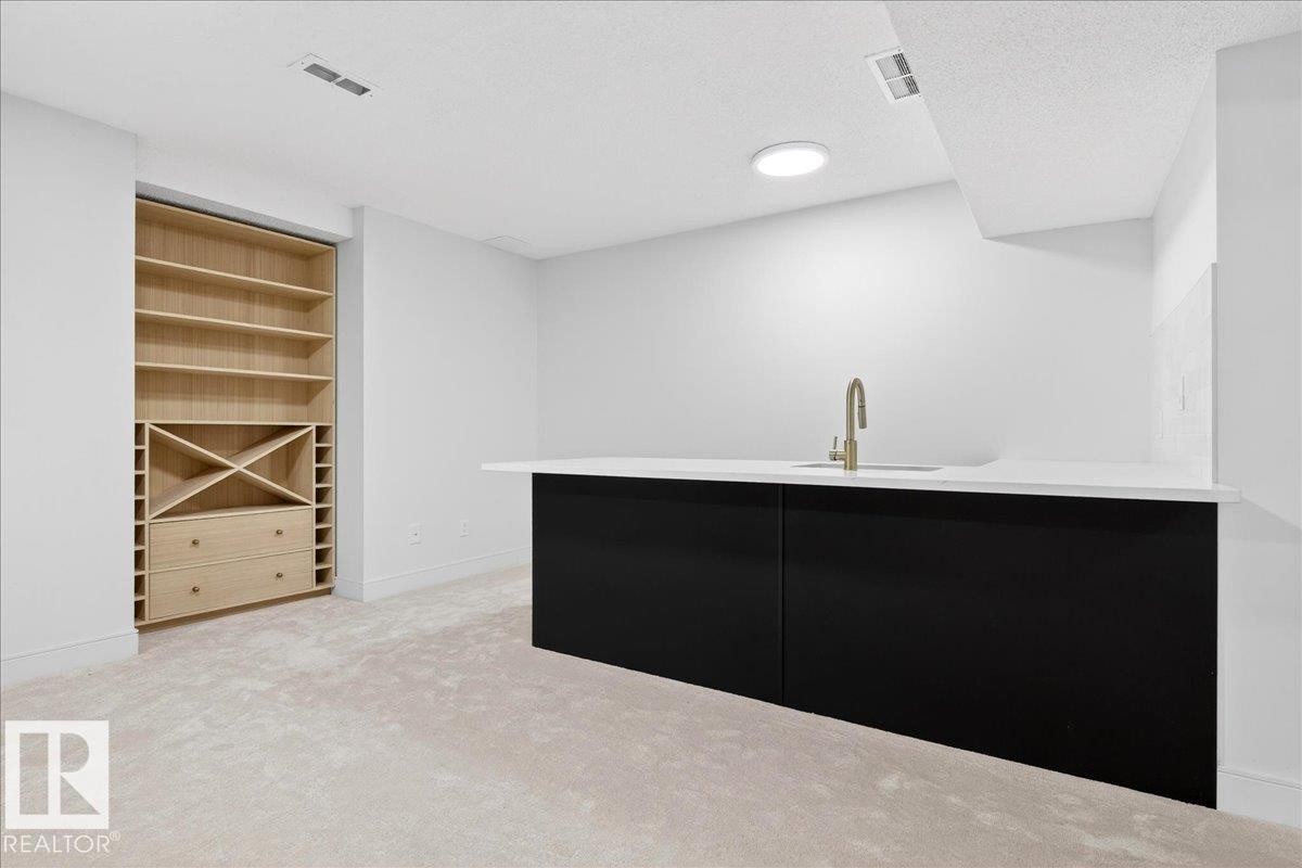Bar with light carpet, modern cabinets, dark cabinets, a textured ceiling, and open shelves - 218 Omand Drive, Edmonton, AB - Indoor Photo Showing Other Room