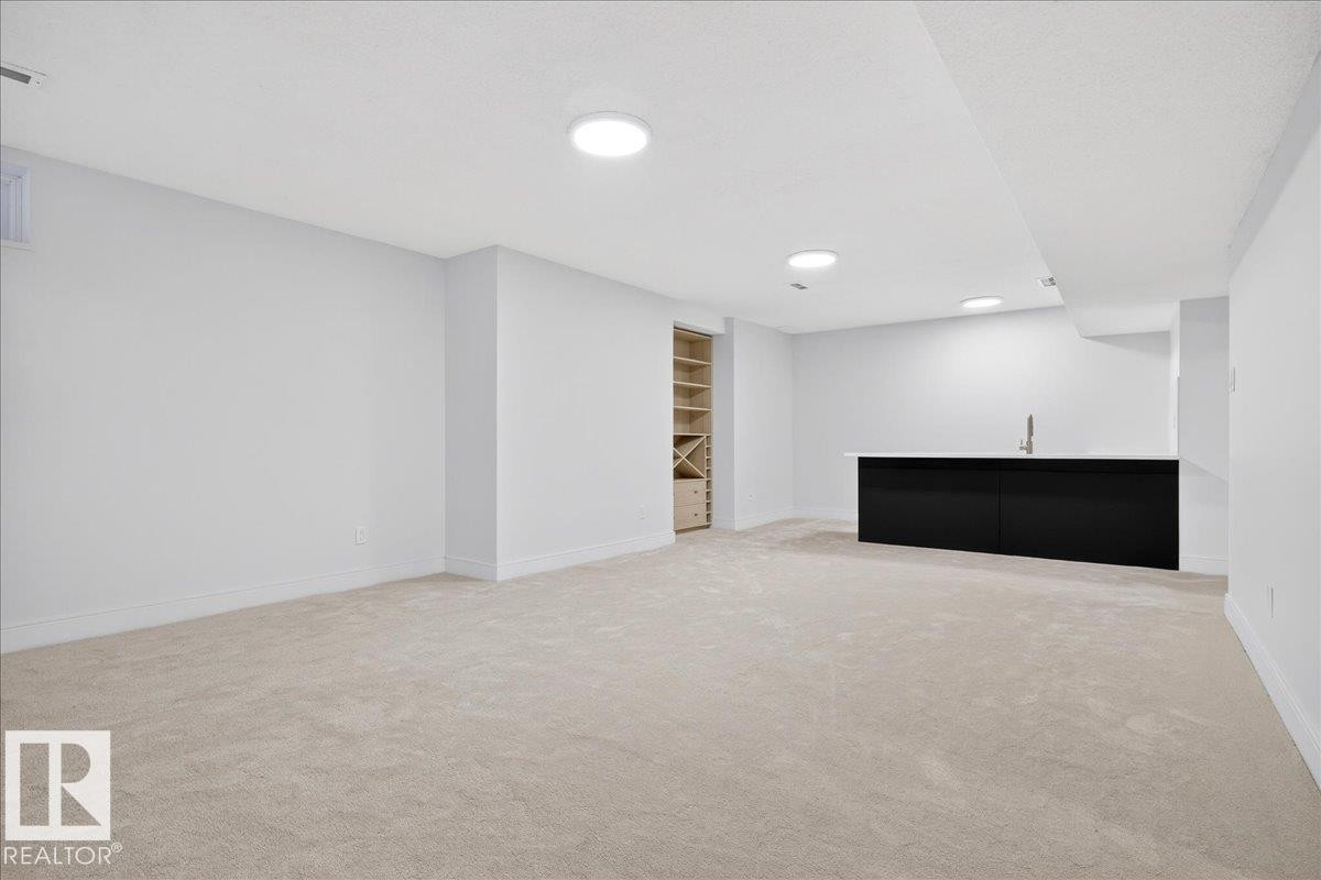 Finished below grade area with light carpet and built in features - 218 Omand Drive, Edmonton, AB - Indoor