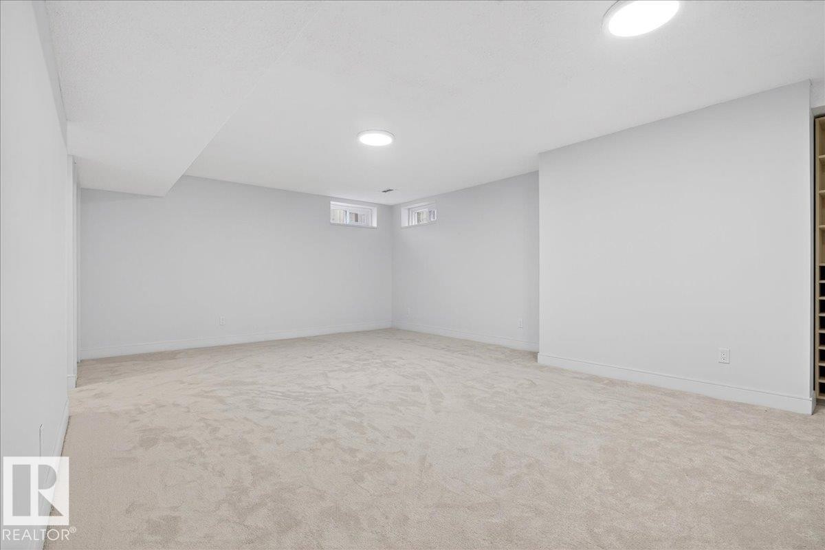 Basement with light carpet and baseboards - 218 Omand Drive, Edmonton, AB - Indoor