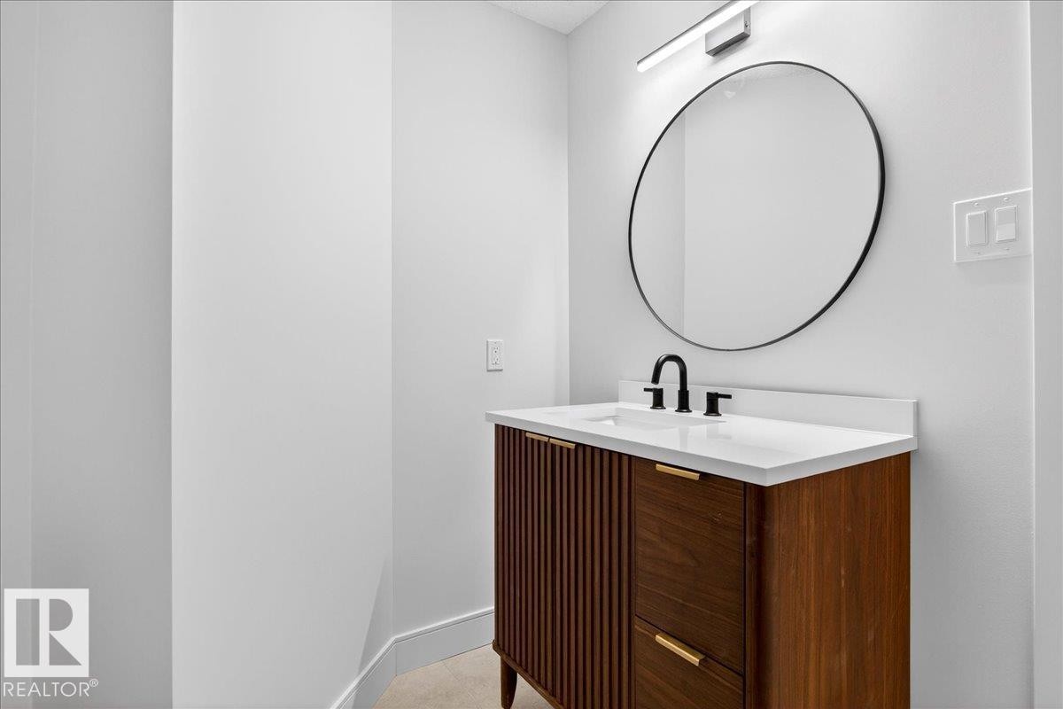 Half bath with vanity and baseboards - 218 Omand Drive, Edmonton, AB - Indoor