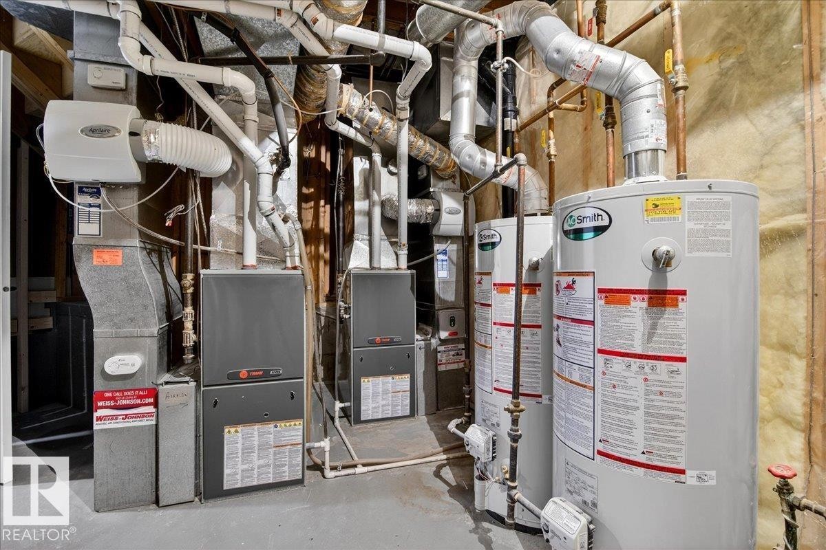 Utility room featuring water heater - 218 Omand Drive, Edmonton, AB - Indoor Photo Showing Basement