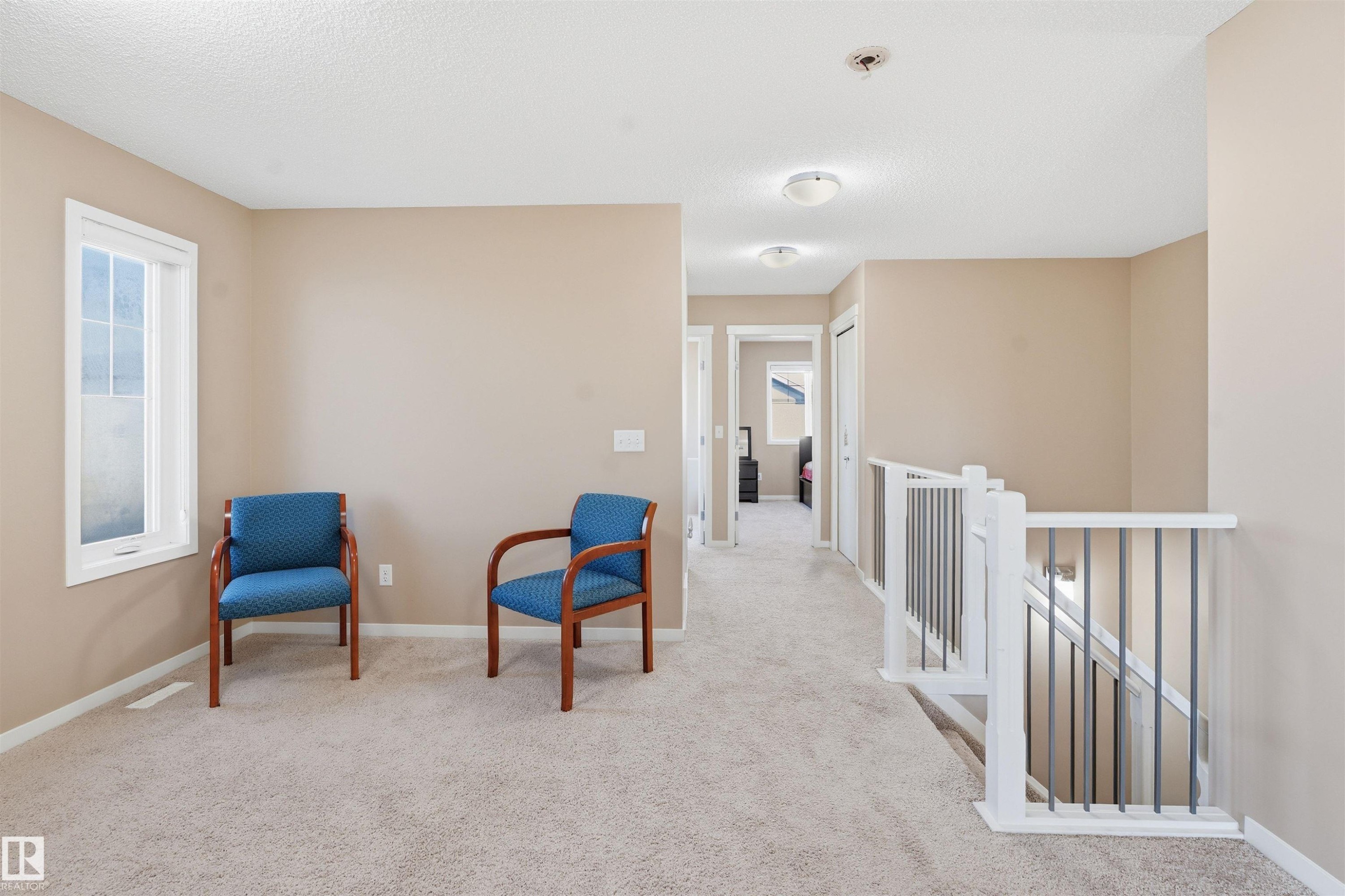 Sitting room featuring an upstairs landing, light colored carpet, and a textured ceiling - 5003 Andison Close, Edmonton, AB - Indoor Photo Showing Other Room