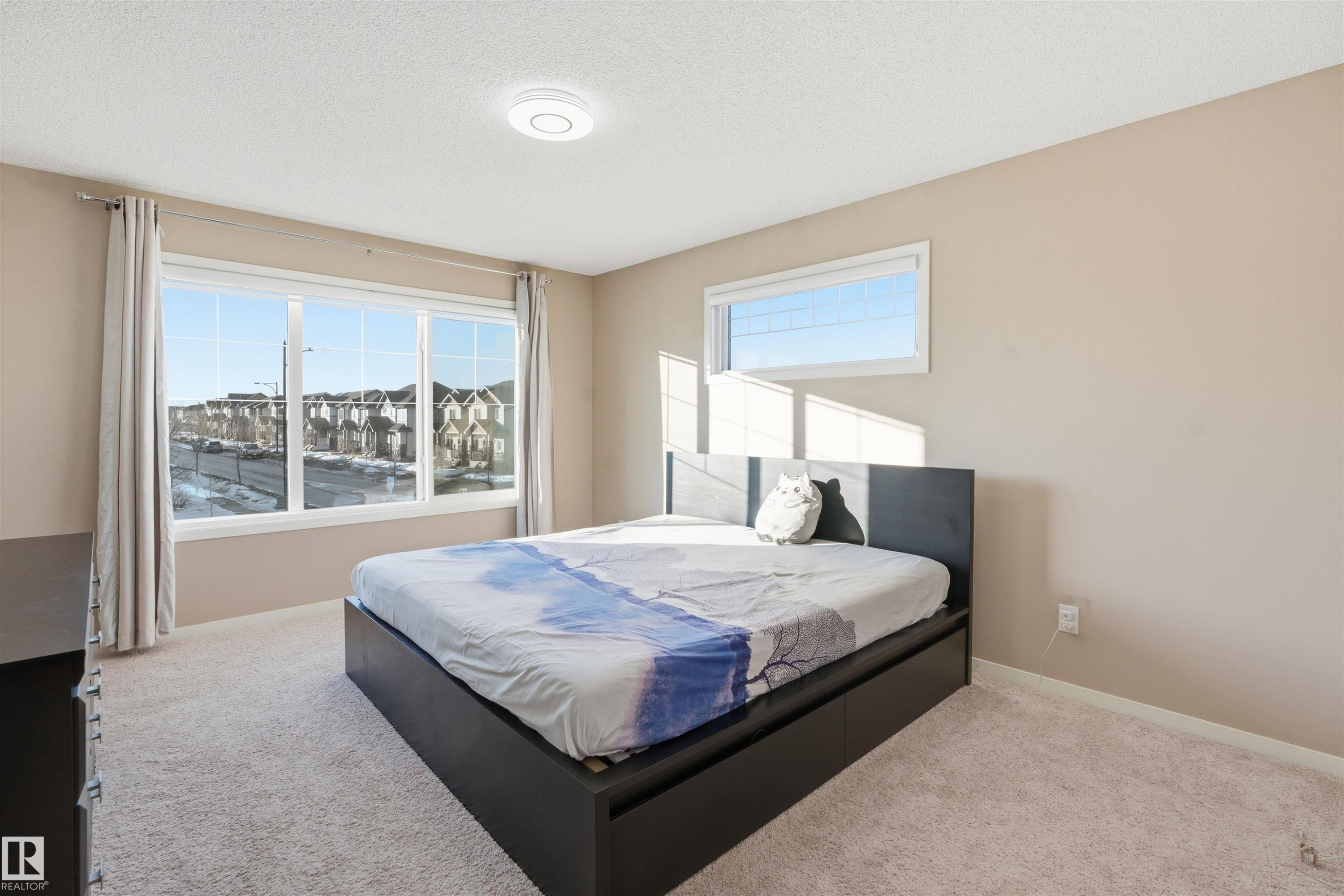 Carpeted bedroom with baseboards and a textured ceiling - 5003 Andison Close, Edmonton, AB - Indoor Photo Showing Bedroom