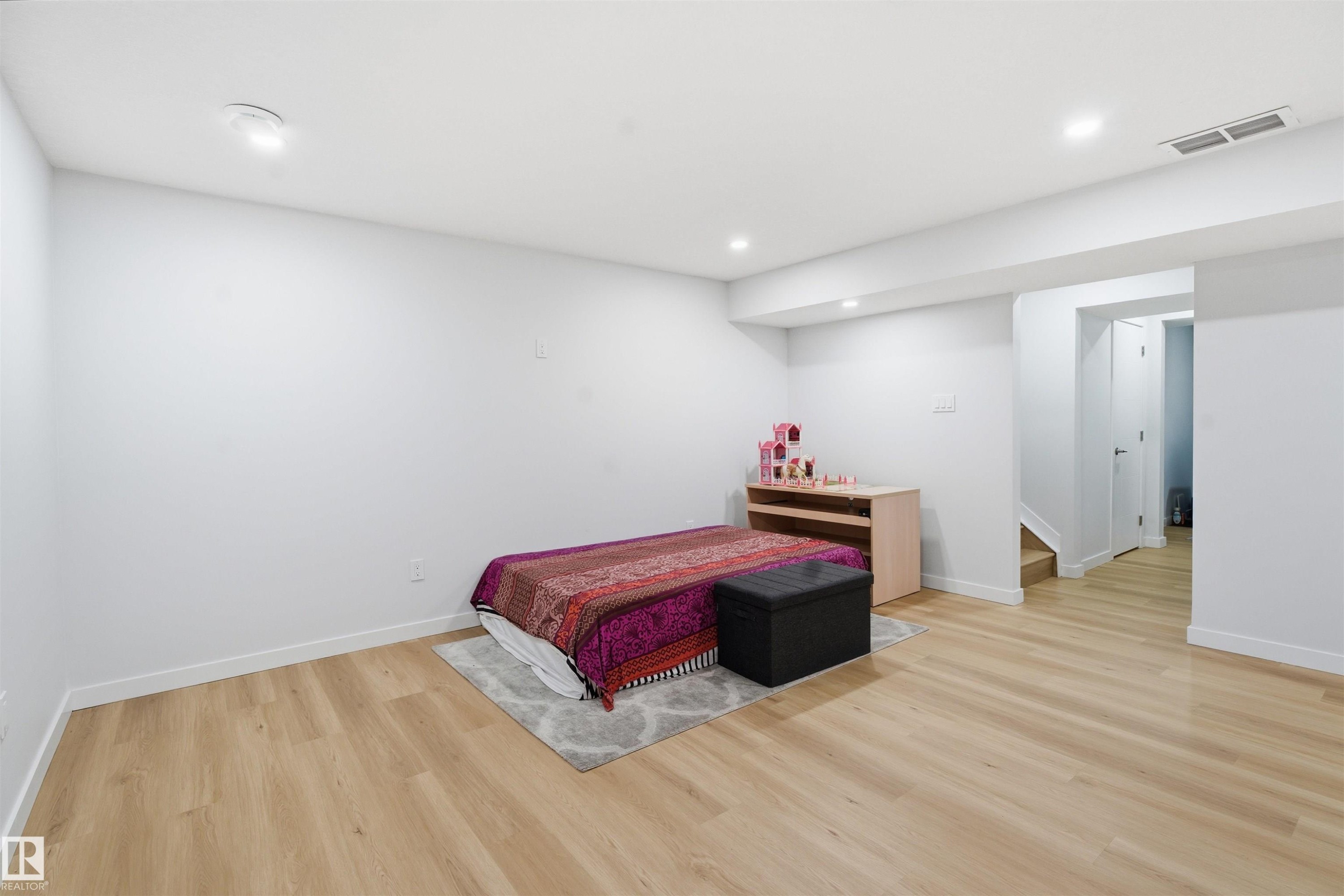 Bedroom with light wood finished floors and recessed lighting - 5003 Andison Close, Edmonton, AB - Indoor