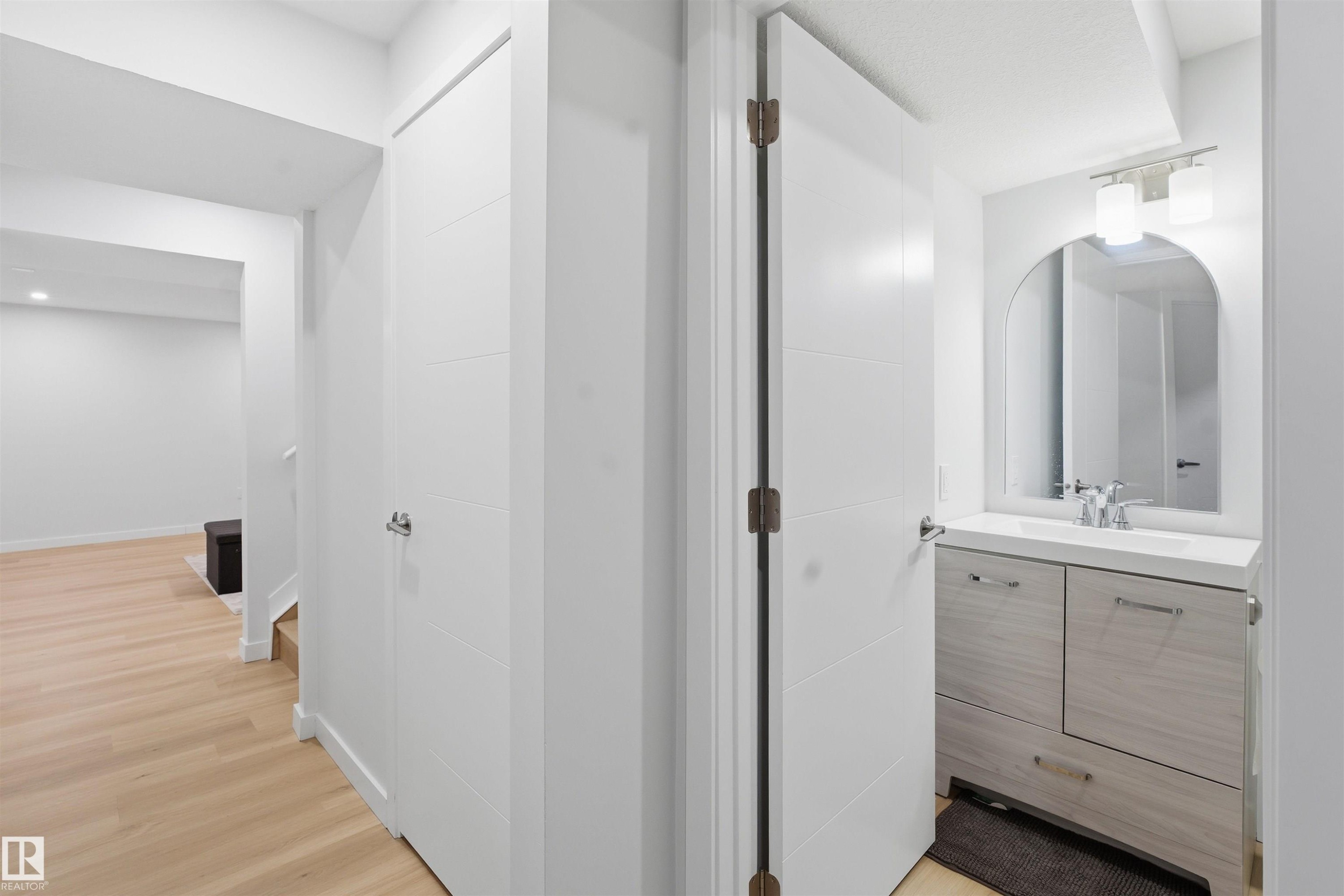 Bathroom featuring vanity and light wood-style flooring - 5003 Andison Close, Edmonton, AB - Indoor