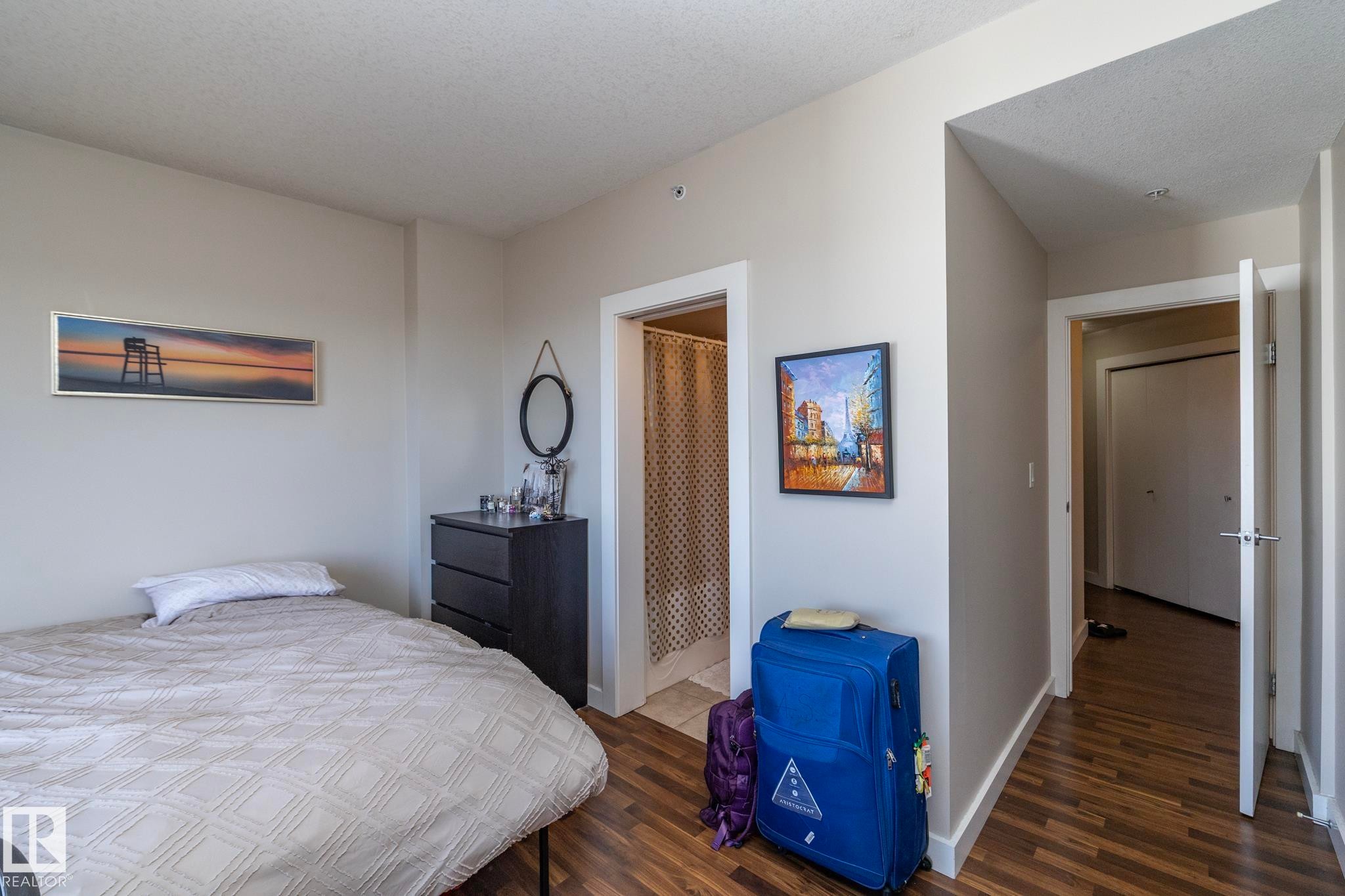 Bedroom with dark wood finished floors - 2005 10136 104 Street, Edmonton, AB - Indoor Photo Showing Bedroom