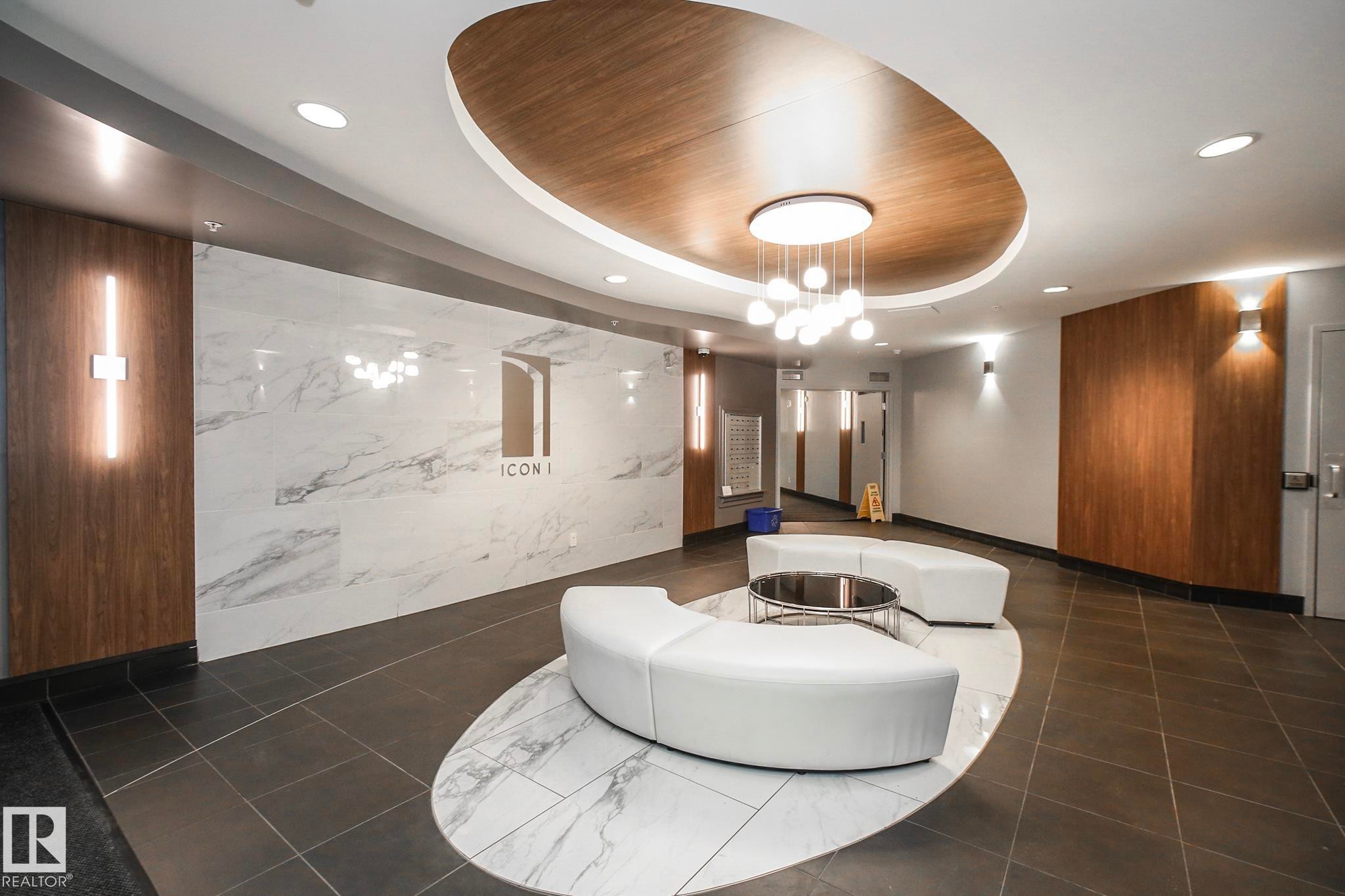 Community lobby featuring a raised ceiling and recessed lighting - 2005 10136 104 Street, Edmonton, AB - Indoor Photo Showing Other Room