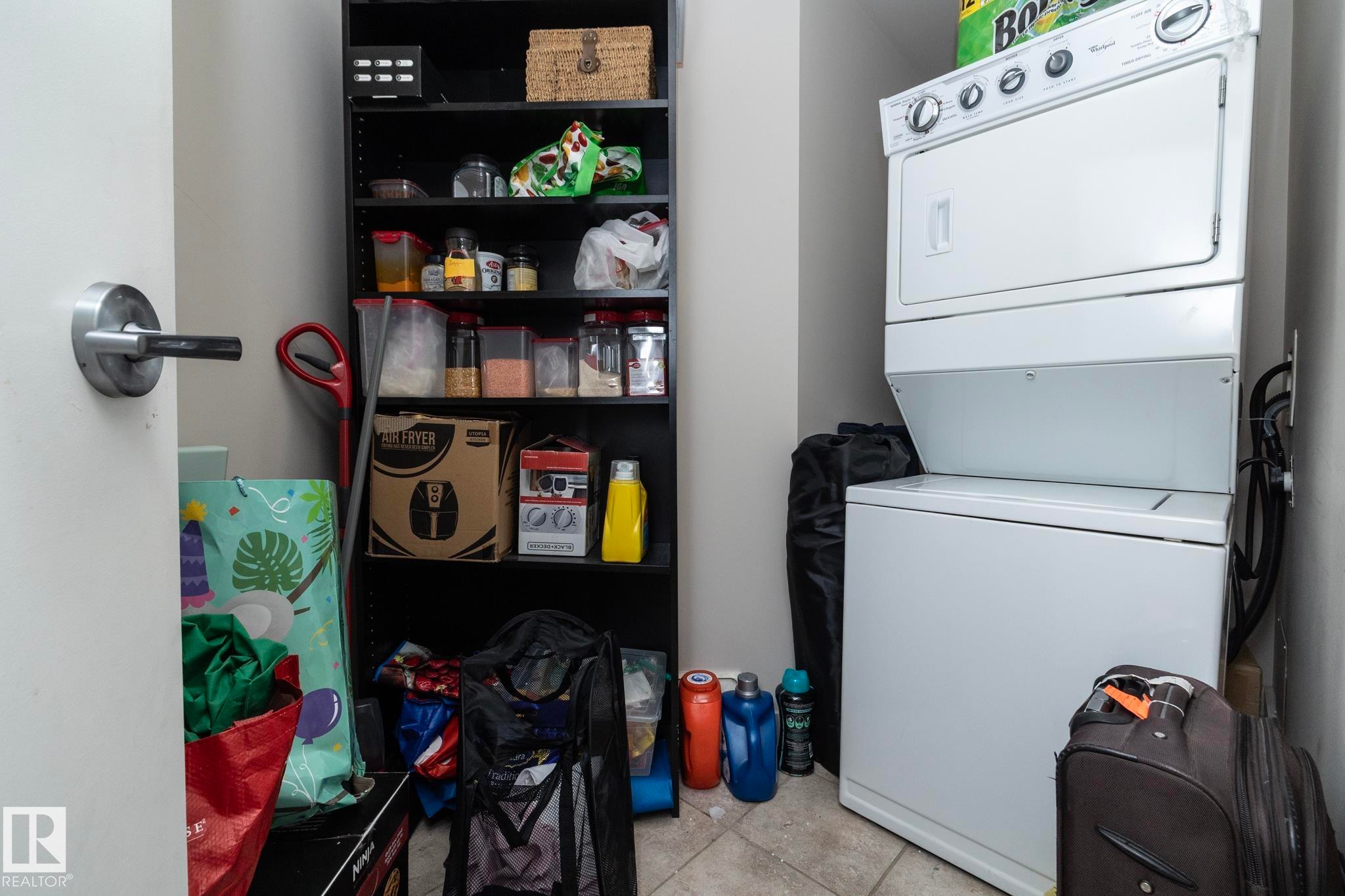 Laundry area with stacked washer / drying machine - 2005 10136 104 Street, Edmonton, AB - Indoor Photo Showing Laundry Room