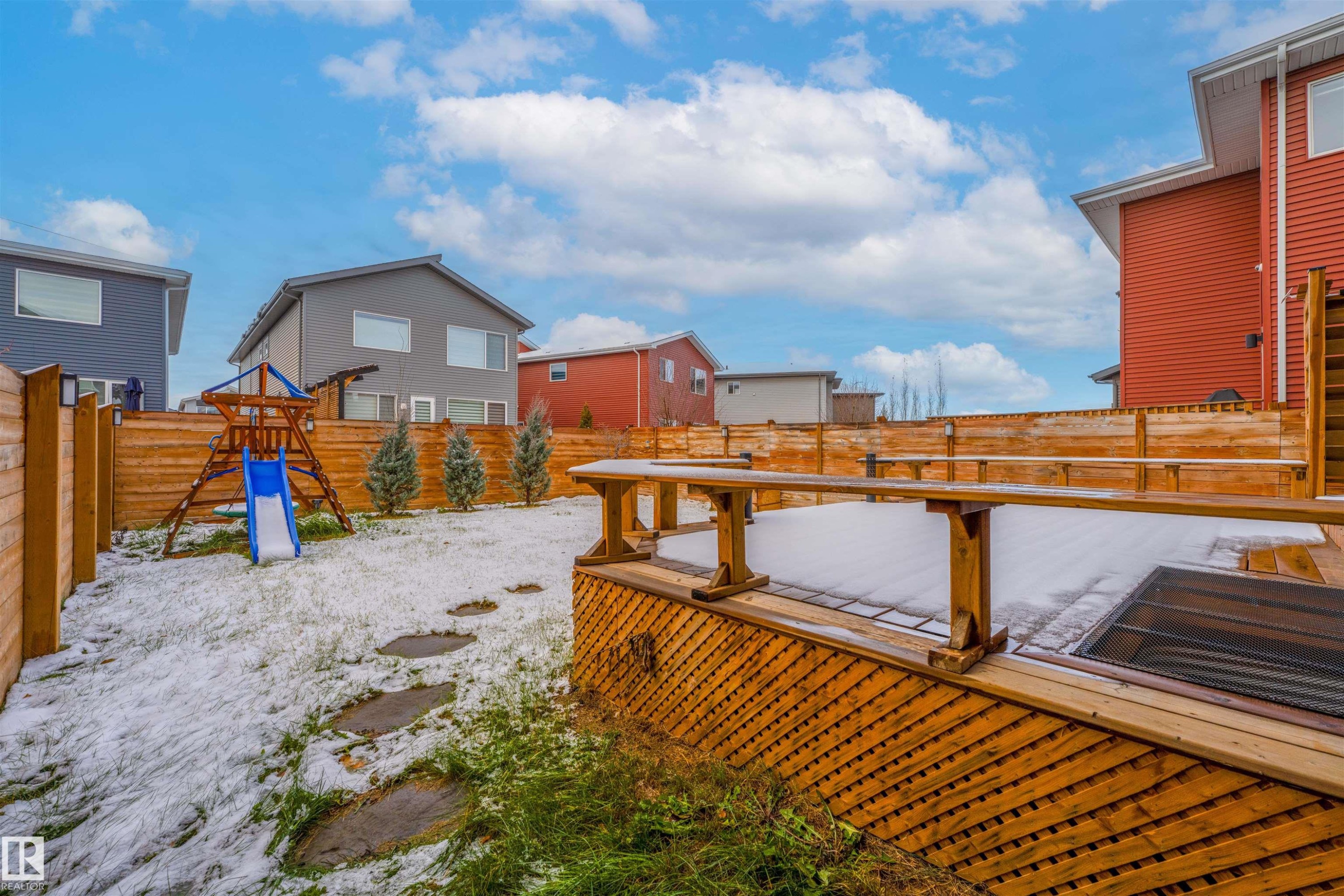 Fenced backyard with a deck, a playground, and a residential view - 2330 Kelly Circle, Edmonton, AB - Outdoor