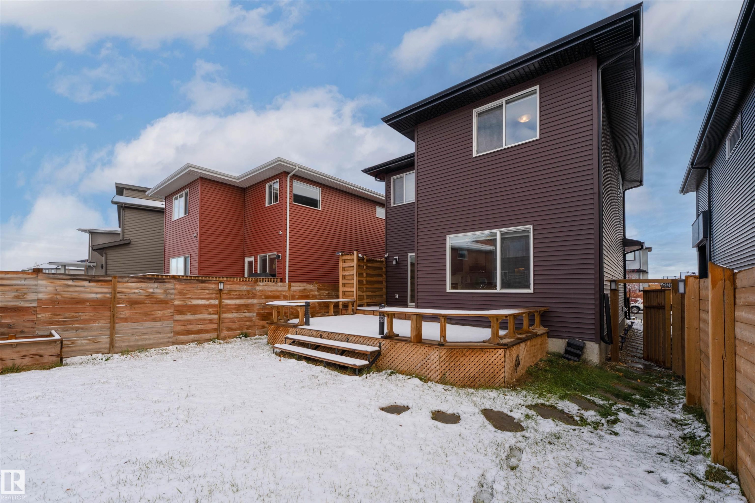 Snow covered back of property featuring a fenced backyard and a deck - 2330 Kelly Circle, Edmonton, AB - Outdoor With Exterior