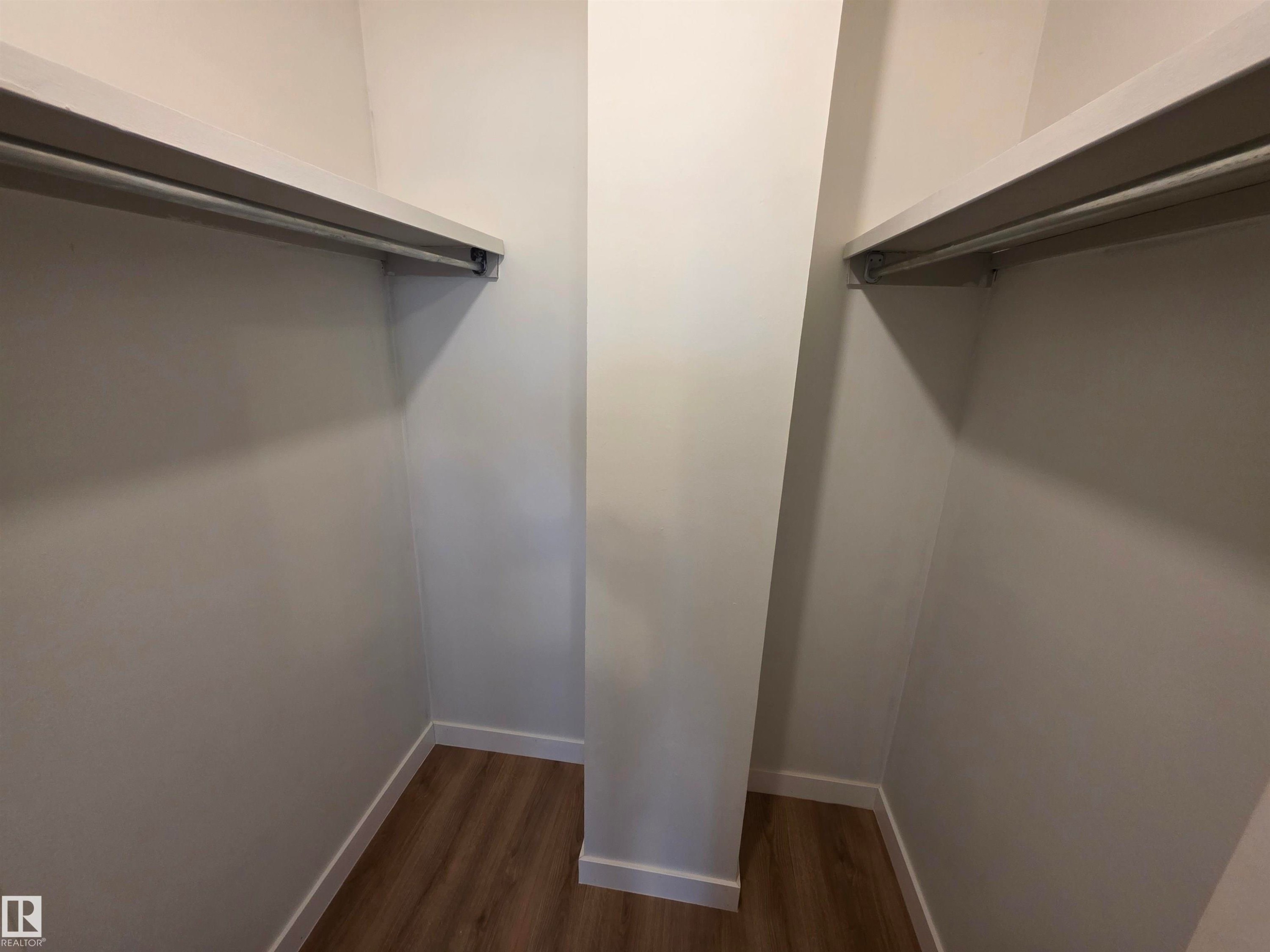 Walk in closet featuring dark wood-style floors - Edmonton, AB - Indoor With Storage