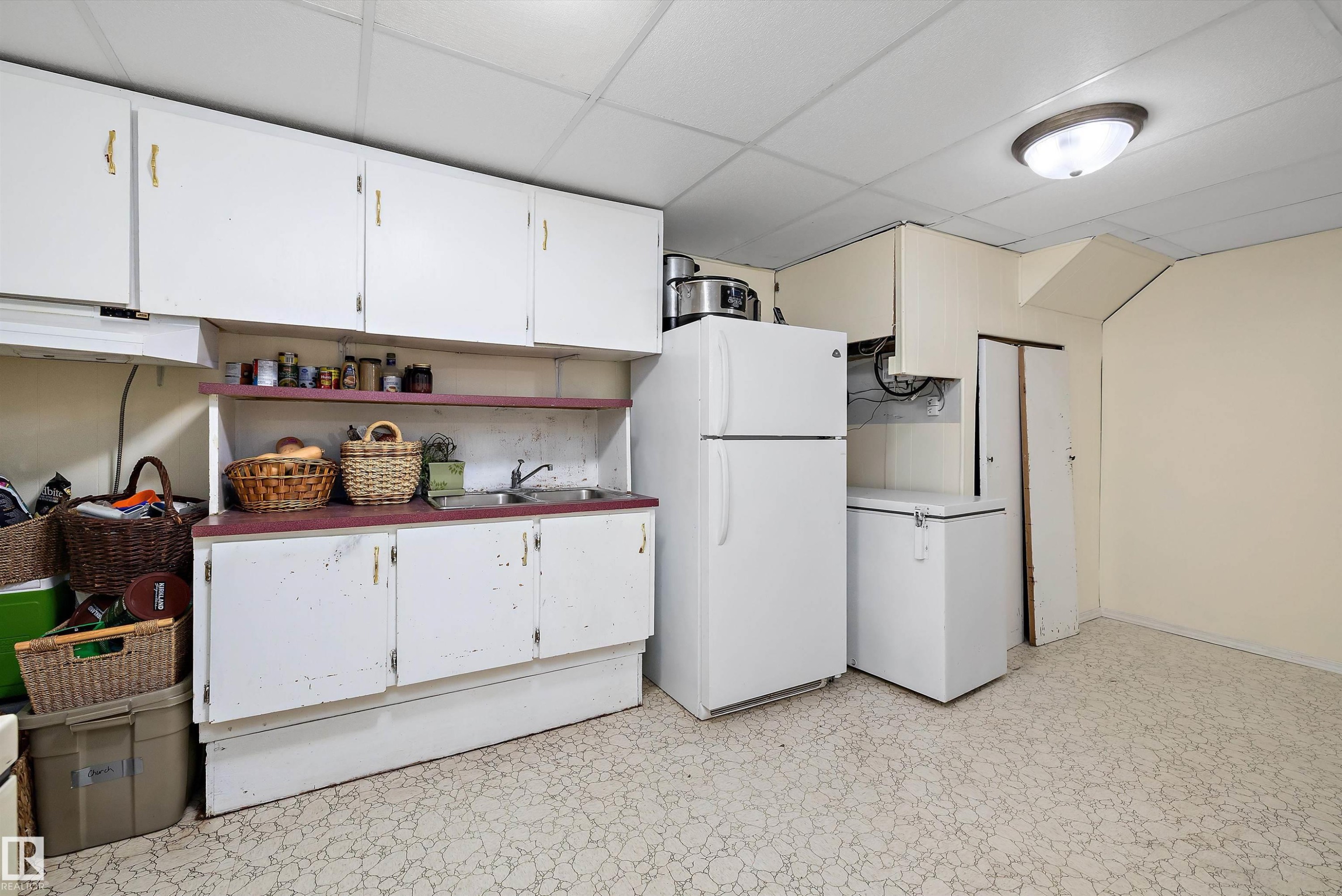 Kitchen with freestanding refrigerator, open shelves, white cabinets, light floors, and a paneled ceiling - 5703 143 Avenue, Edmonton, AB - Indoor Photo Showing Kitchen