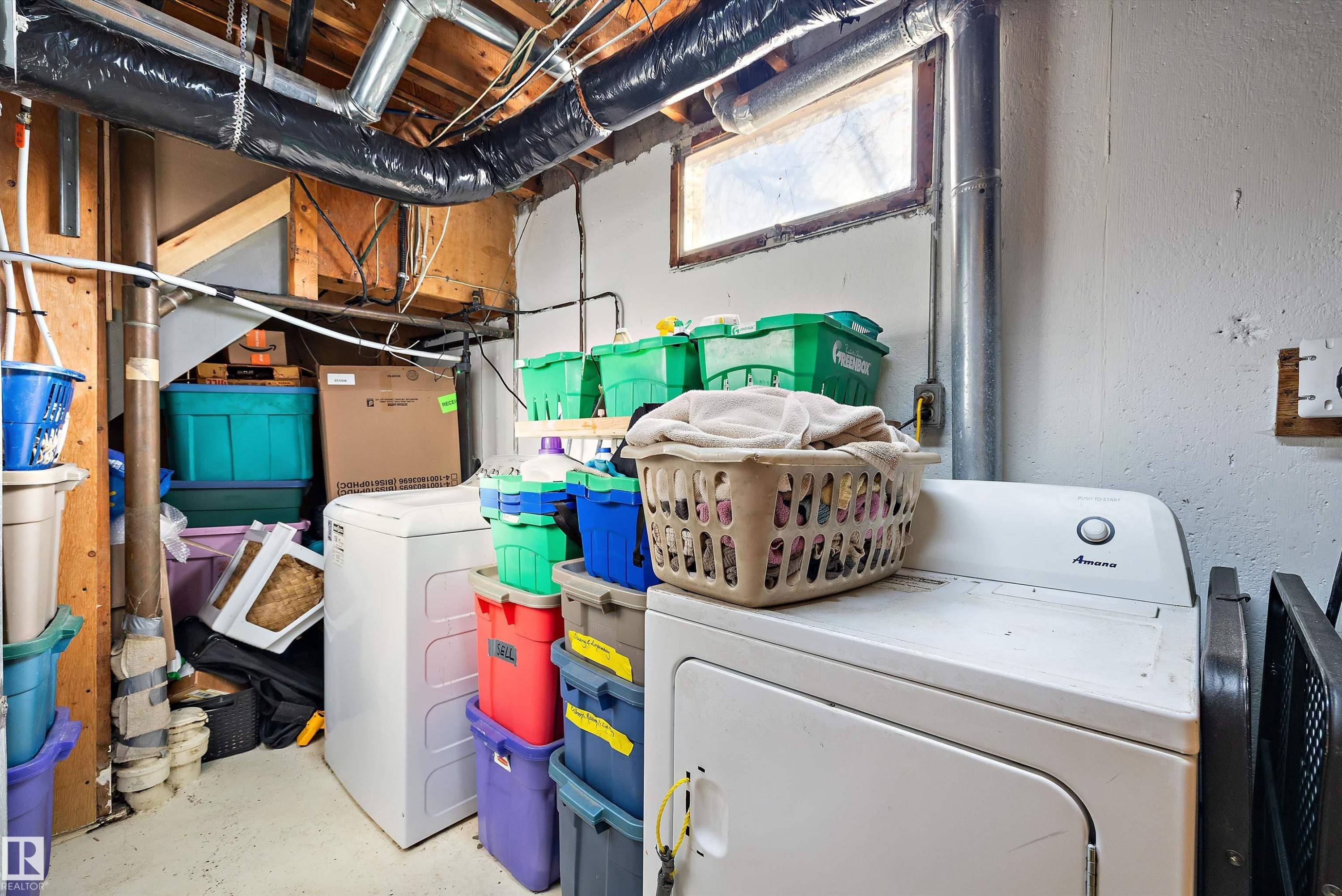 Laundry area with unfinished concrete flooring and washing machine and dryer - 5703 143 Avenue, Edmonton, AB - Indoor Photo Showing Laundry Room