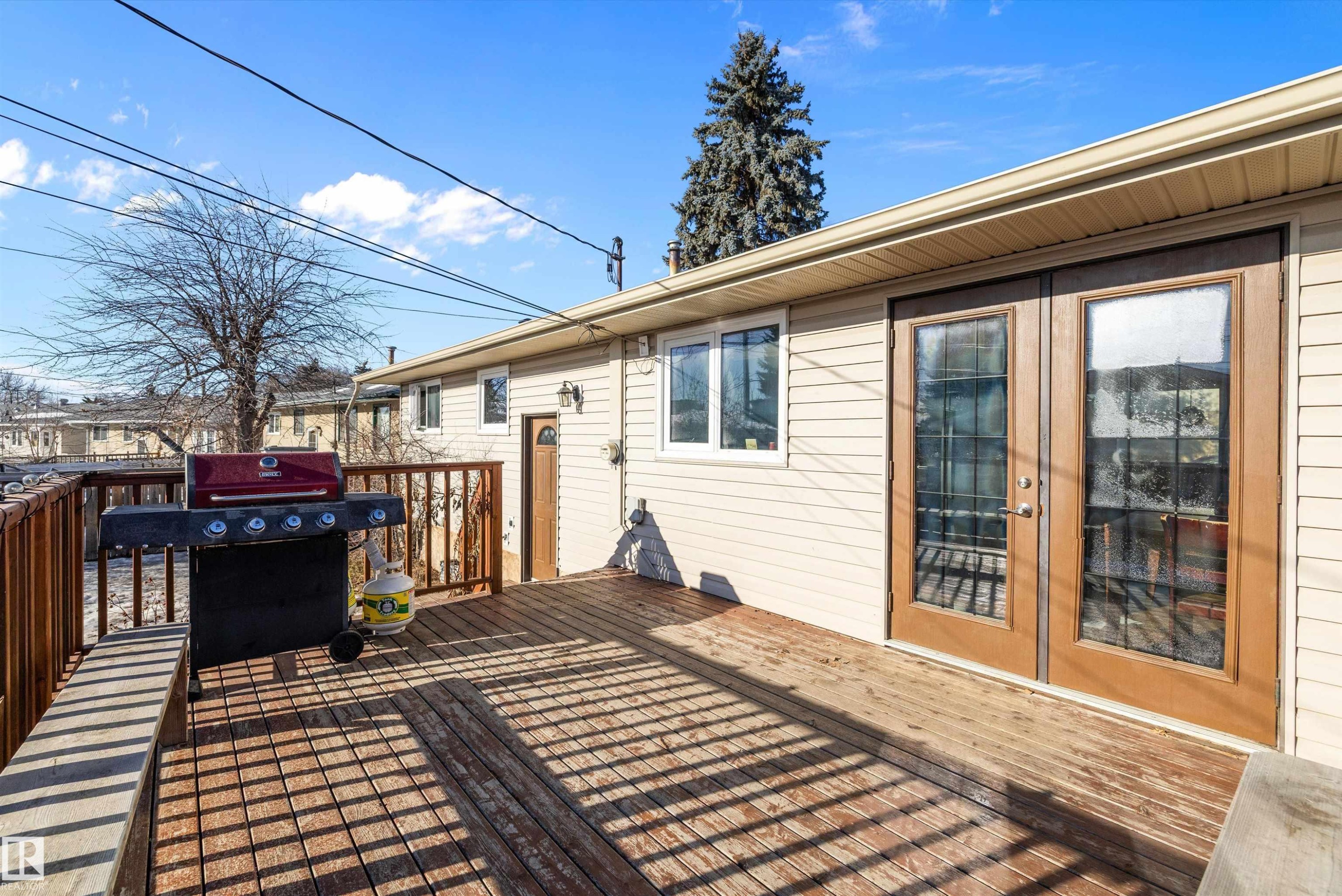 Wooden terrace featuring french doors and area for grilling - 5703 143 Avenue, Edmonton, AB - Outdoor With Deck Patio Veranda