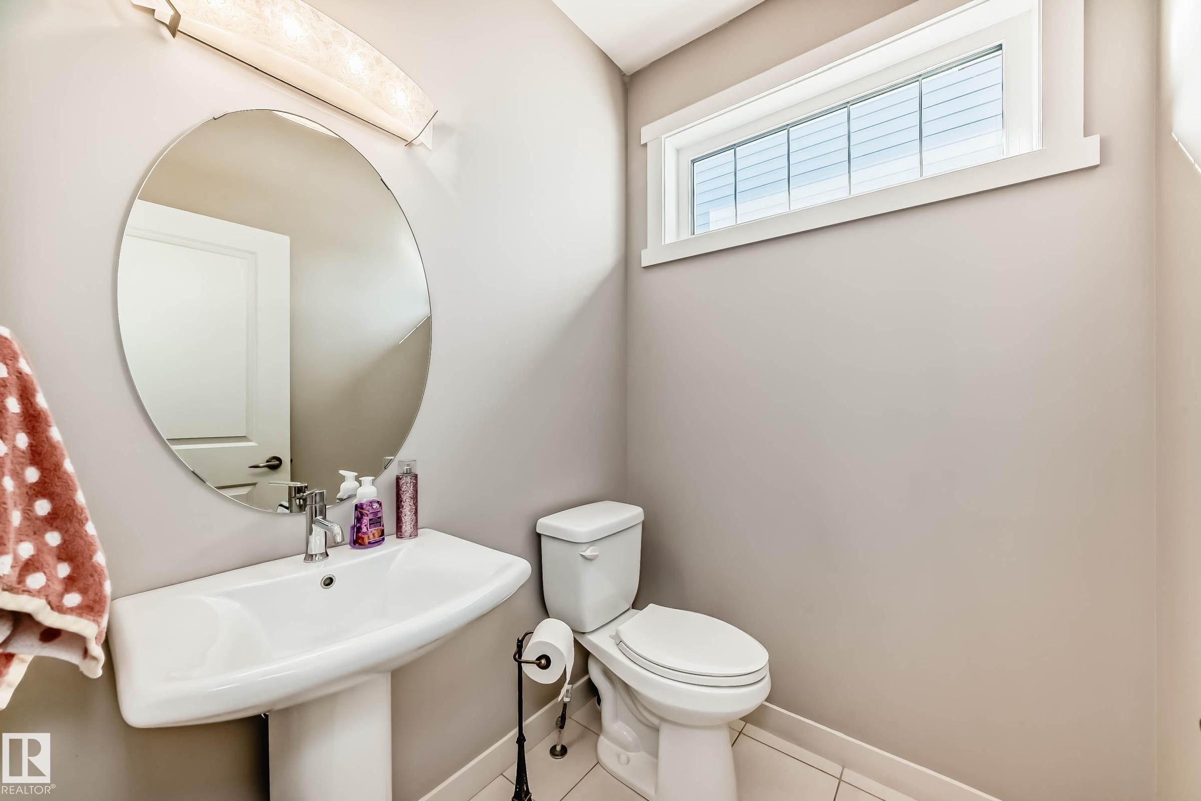 Half bathroom with toilet and tile patterned flooring - 7719 Getty Wynd, Edmonton, AB - Indoor Photo Showing Bathroom