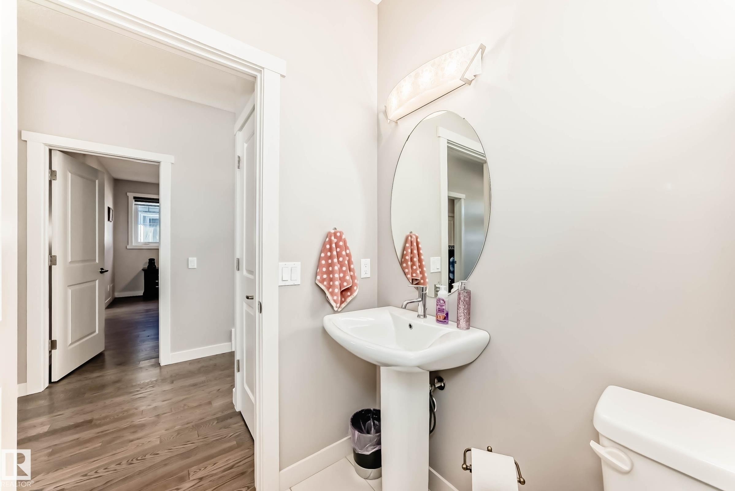 Half bath featuring toilet and wood finished floors - 7719 Getty Wynd, Edmonton, AB - Indoor Photo Showing Bathroom