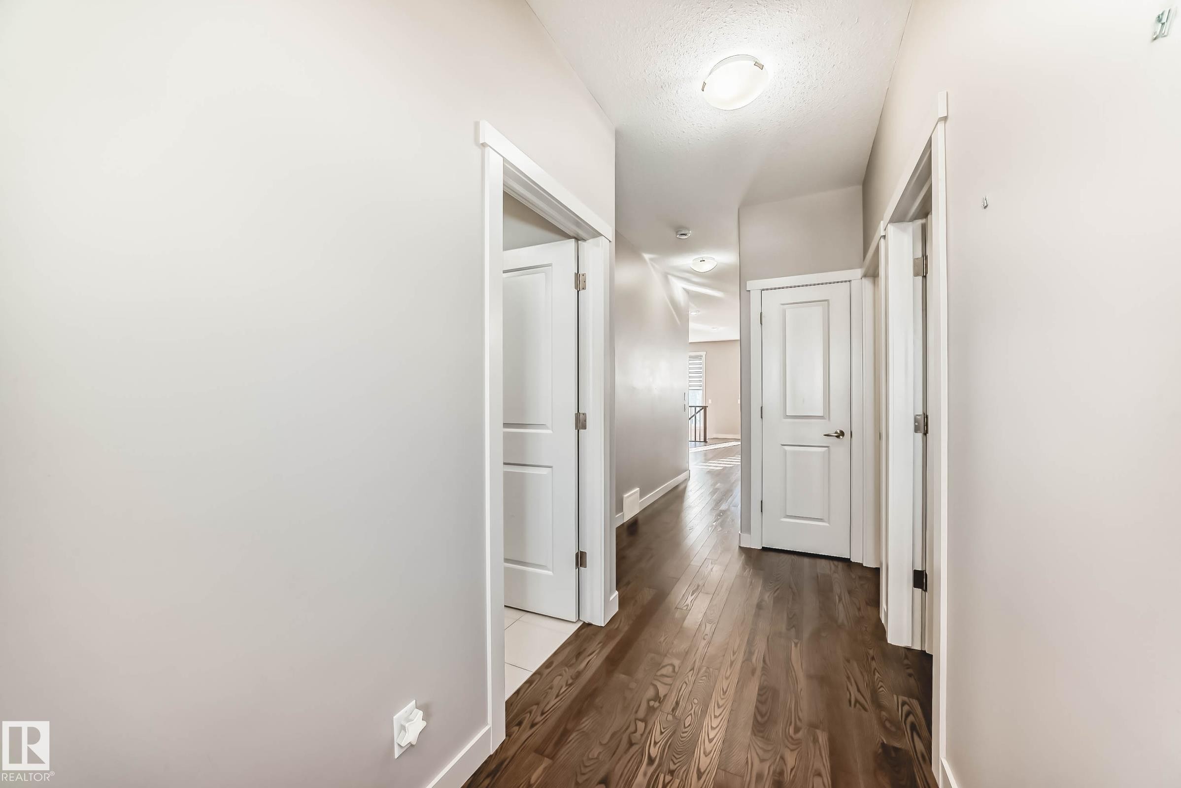 Corridor featuring dark wood-style floors and a textured ceiling - 7719 Getty Wynd, Edmonton, AB - Indoor Photo Showing Other Room