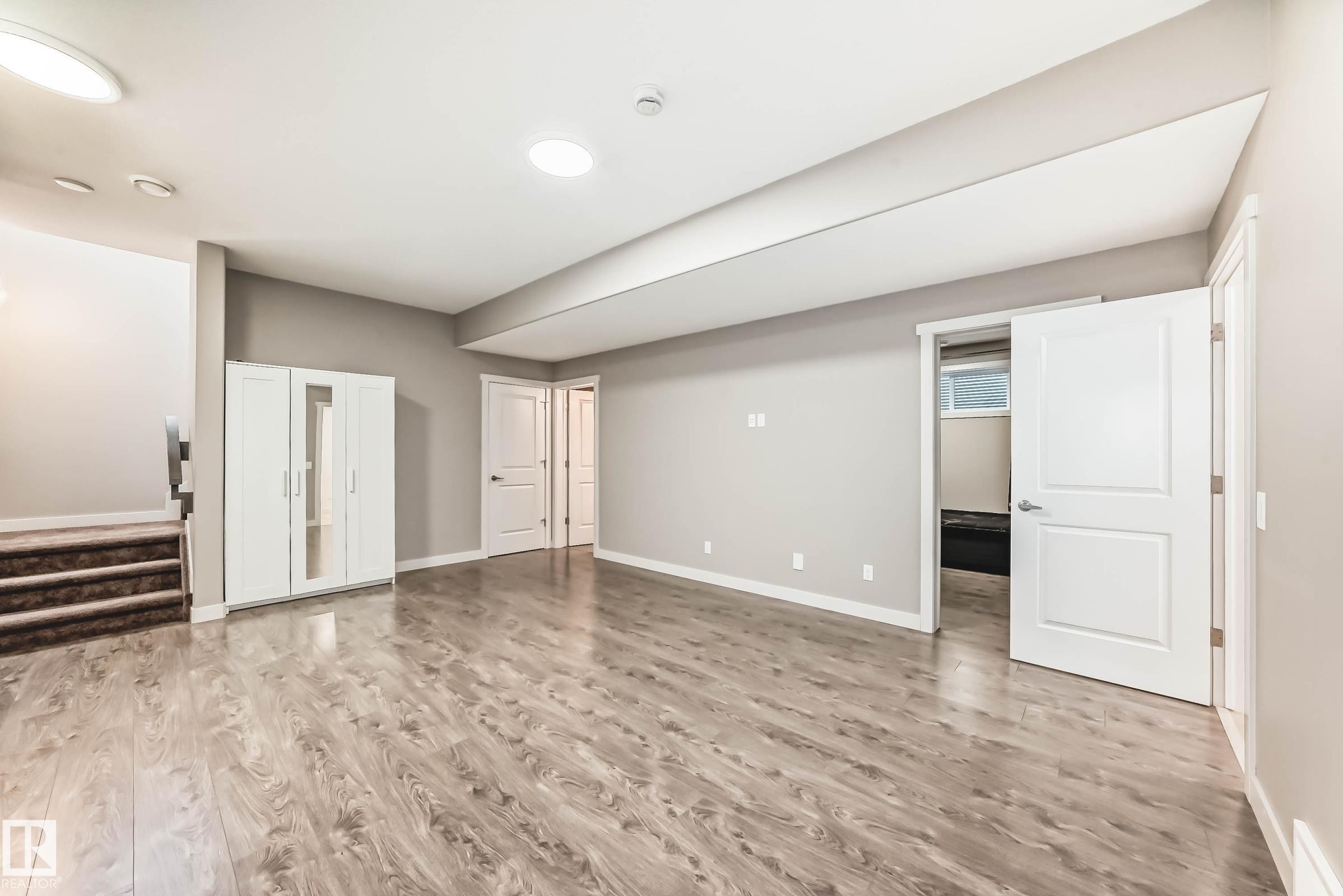 Below grade area with light wood-type flooring - 7719 Getty Wynd, Edmonton, AB - Indoor Photo Showing Other Room