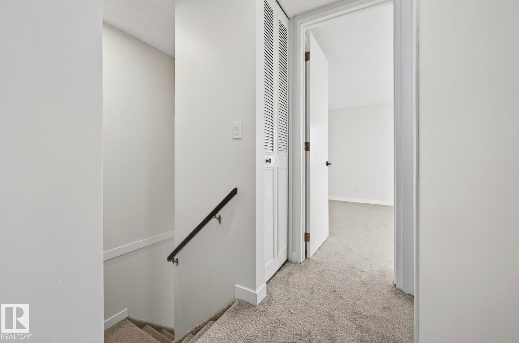 Corridor with an upstairs landing and light colored carpet - 9969 171 Ave, Edmonton, AB - Indoor Photo Showing Other Room