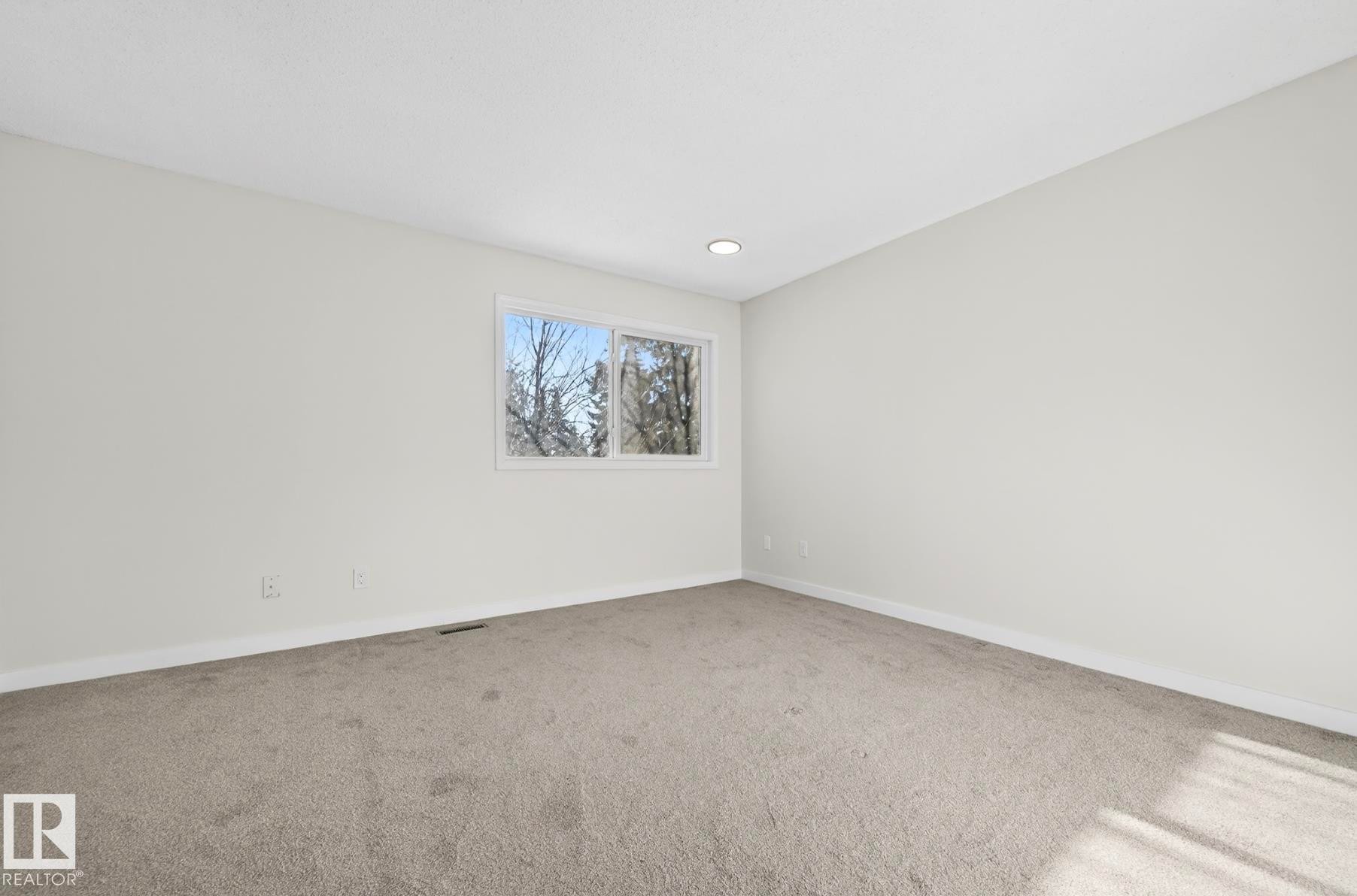 Empty room featuring carpet floors - 9969 171 Ave, Edmonton, AB - Indoor Photo Showing Other Room