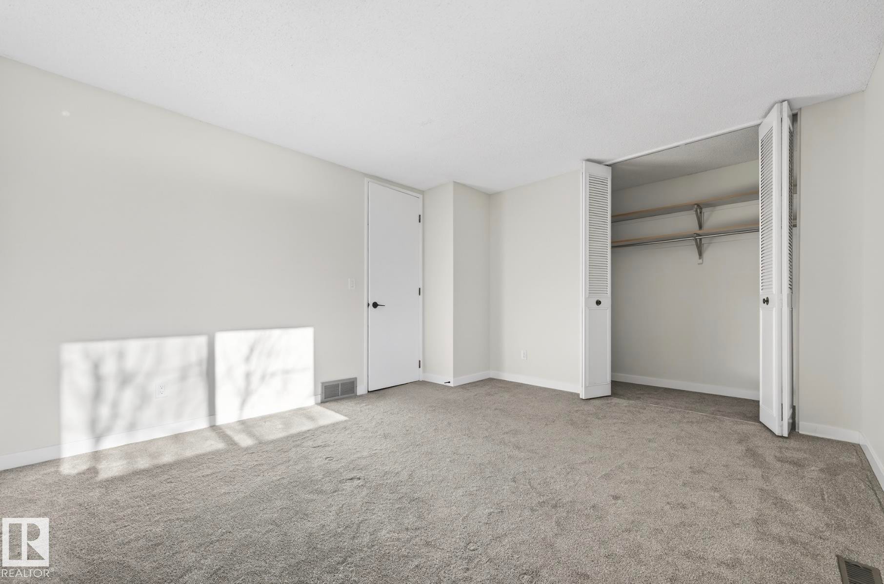 Unfurnished bedroom with light colored carpet and a closet - 9969 171 Ave, Edmonton, AB - Indoor Photo Showing Other Room