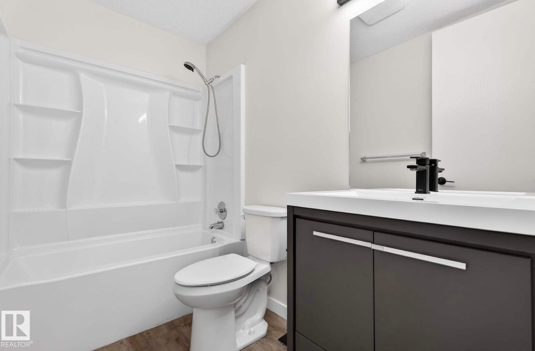 Bathroom featuring shower / tub combination and vanity - 9969 171 Ave, Edmonton, AB - Indoor Photo Showing Bathroom
