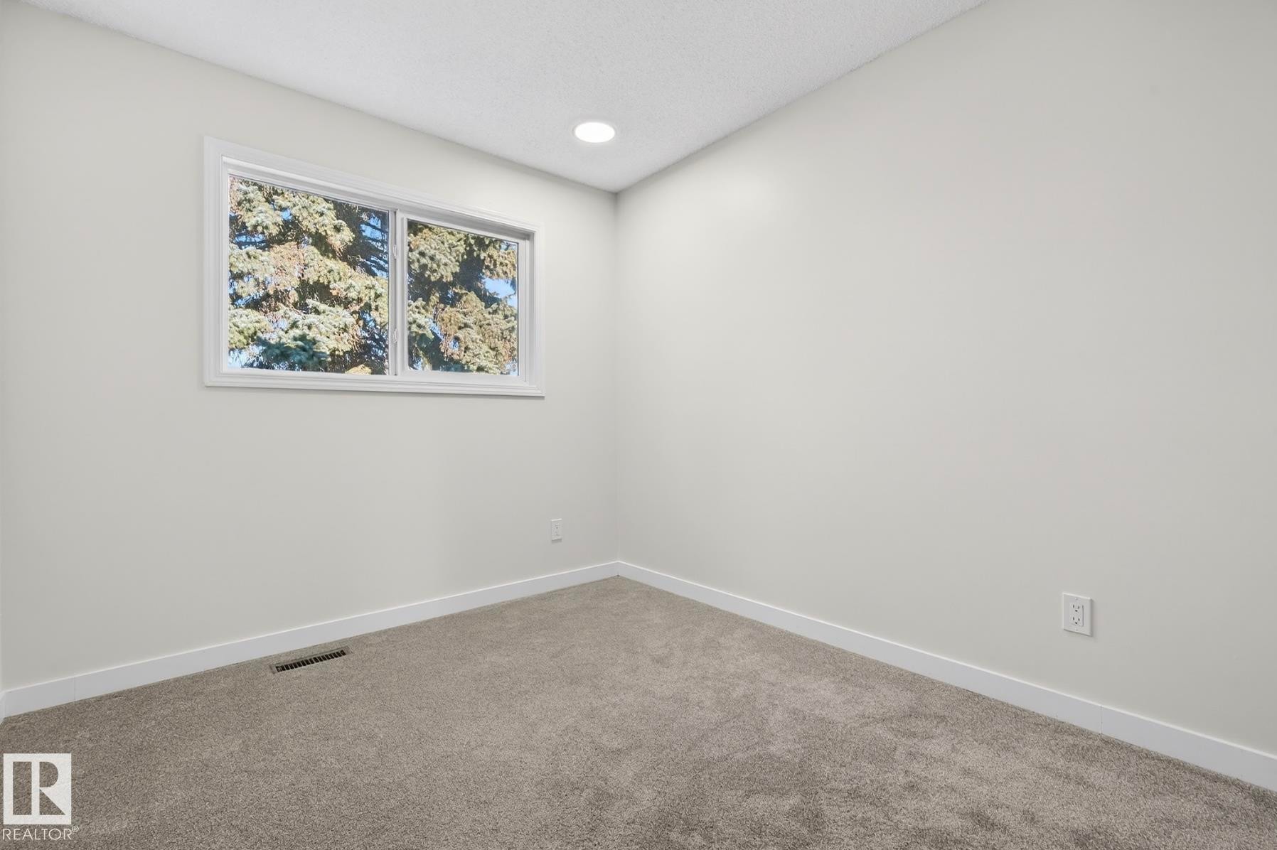 Carpeted empty room featuring baseboards and recessed lighting - 9969 171 Ave, Edmonton, AB - Indoor Photo Showing Other Room