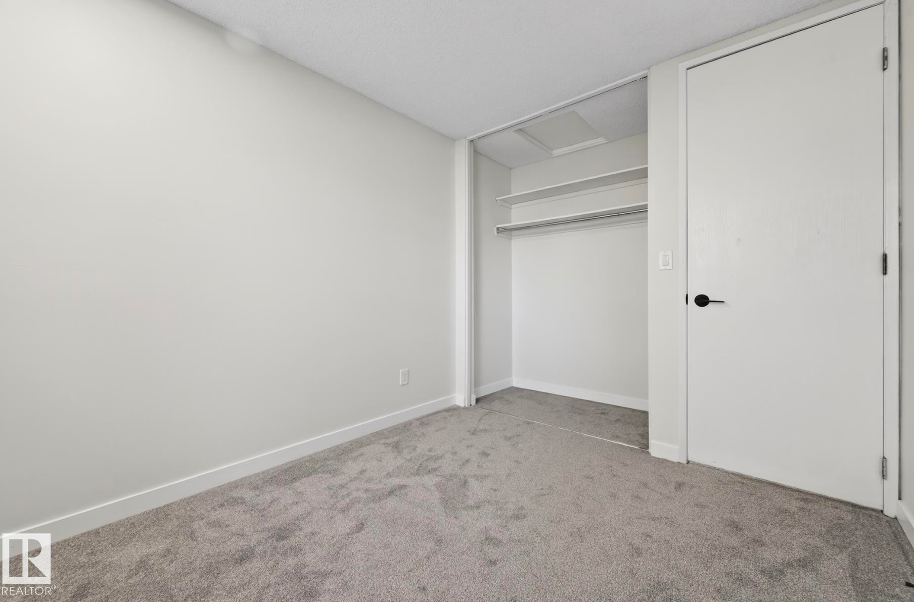 Unfurnished bedroom featuring light colored carpet and a closet - 9969 171 Ave, Edmonton, AB - Indoor Photo Showing Other Room